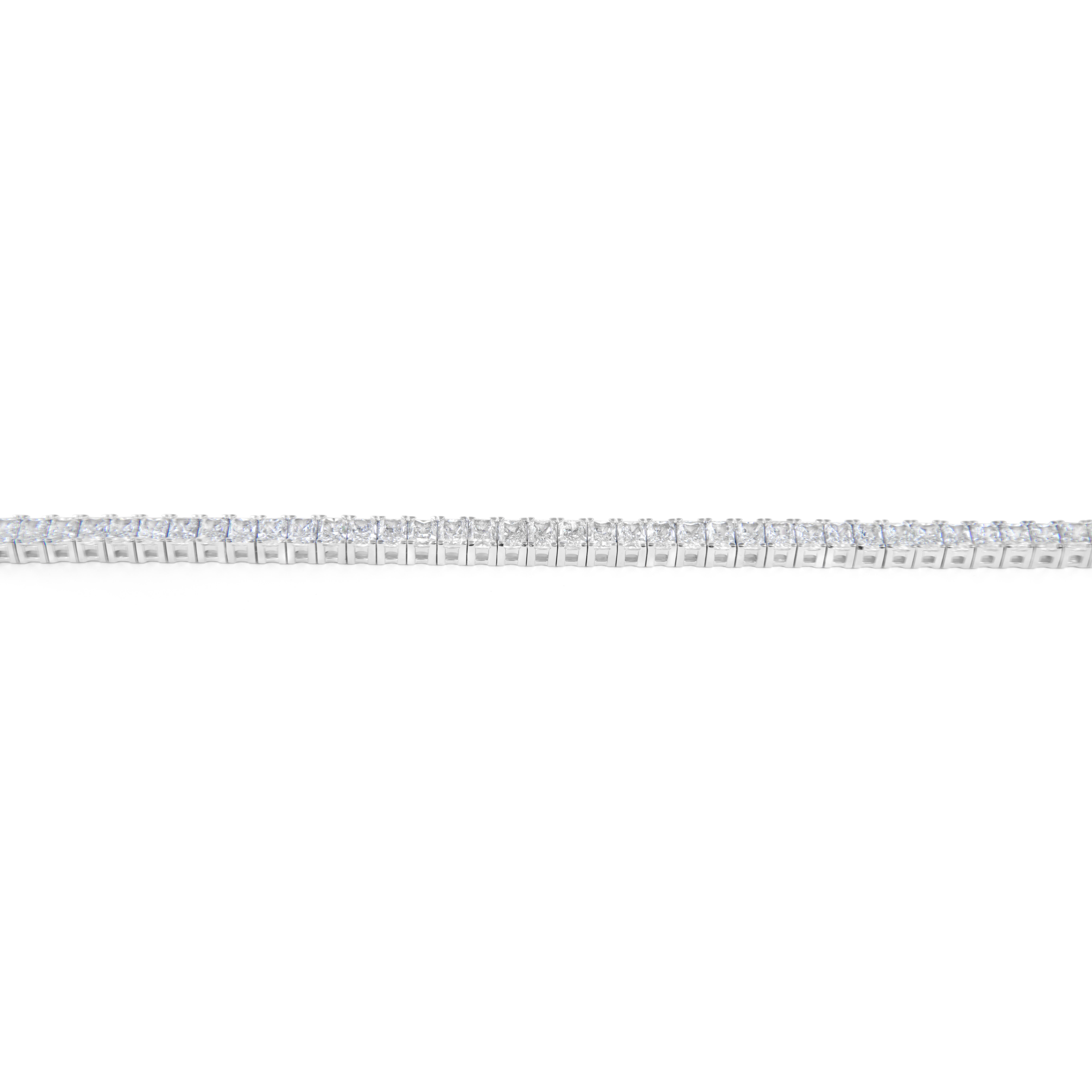 Stunning modern straight natural radiant cut diamond tennis bracelet. High jewelry by Alexander Beverly Hills.
55 radiant cut diamonds, 13.47 carats. Approximately H/I color and VS1/VS2 clarity. 18k white gold, 17.80 grams, 7.25in.
Accommodated with