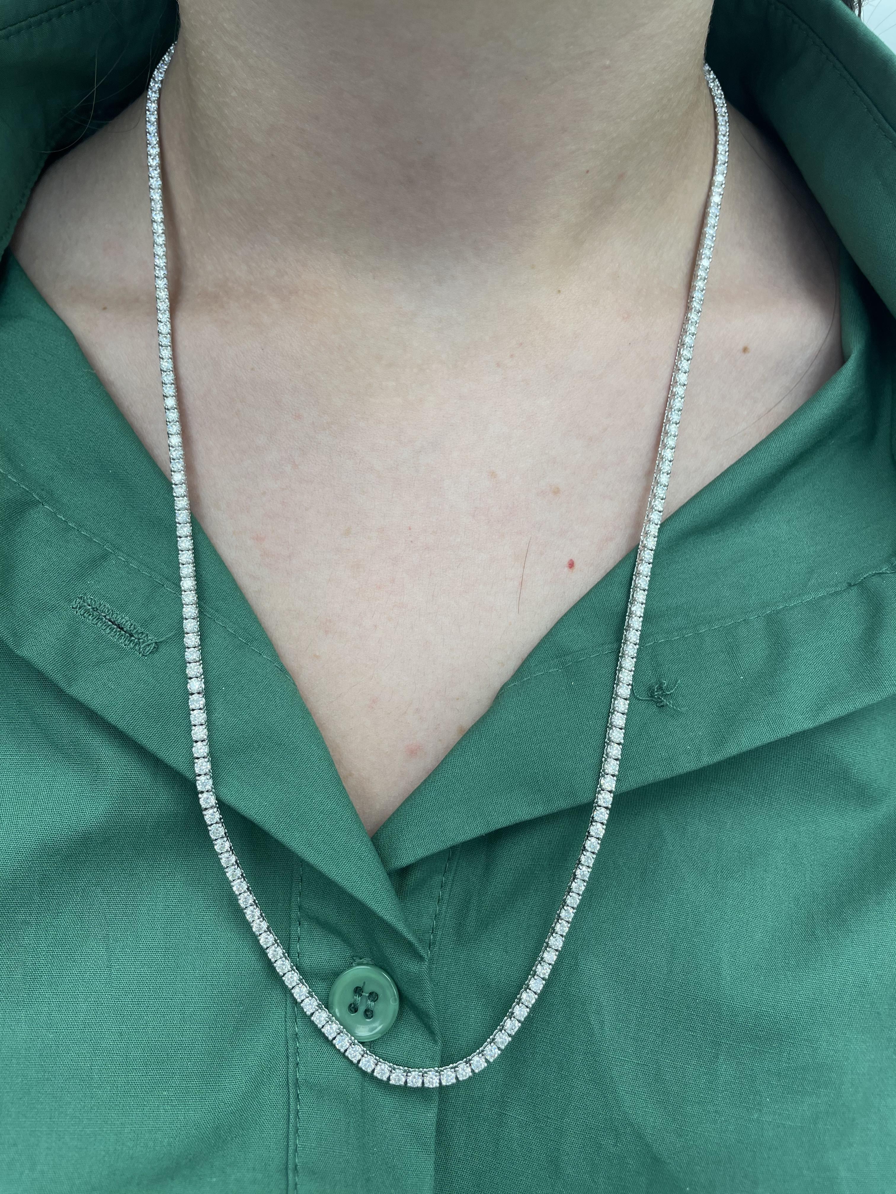 Beautiful and classic natural diamond tennis necklace, by Alexander Beverly Hills.
219 round brilliant diamonds, 13.86 carats. Approximately E color and VS1clarity. 14-karat white gold, 23.39 grams, prong set, 24 inches.
Accommodated with an