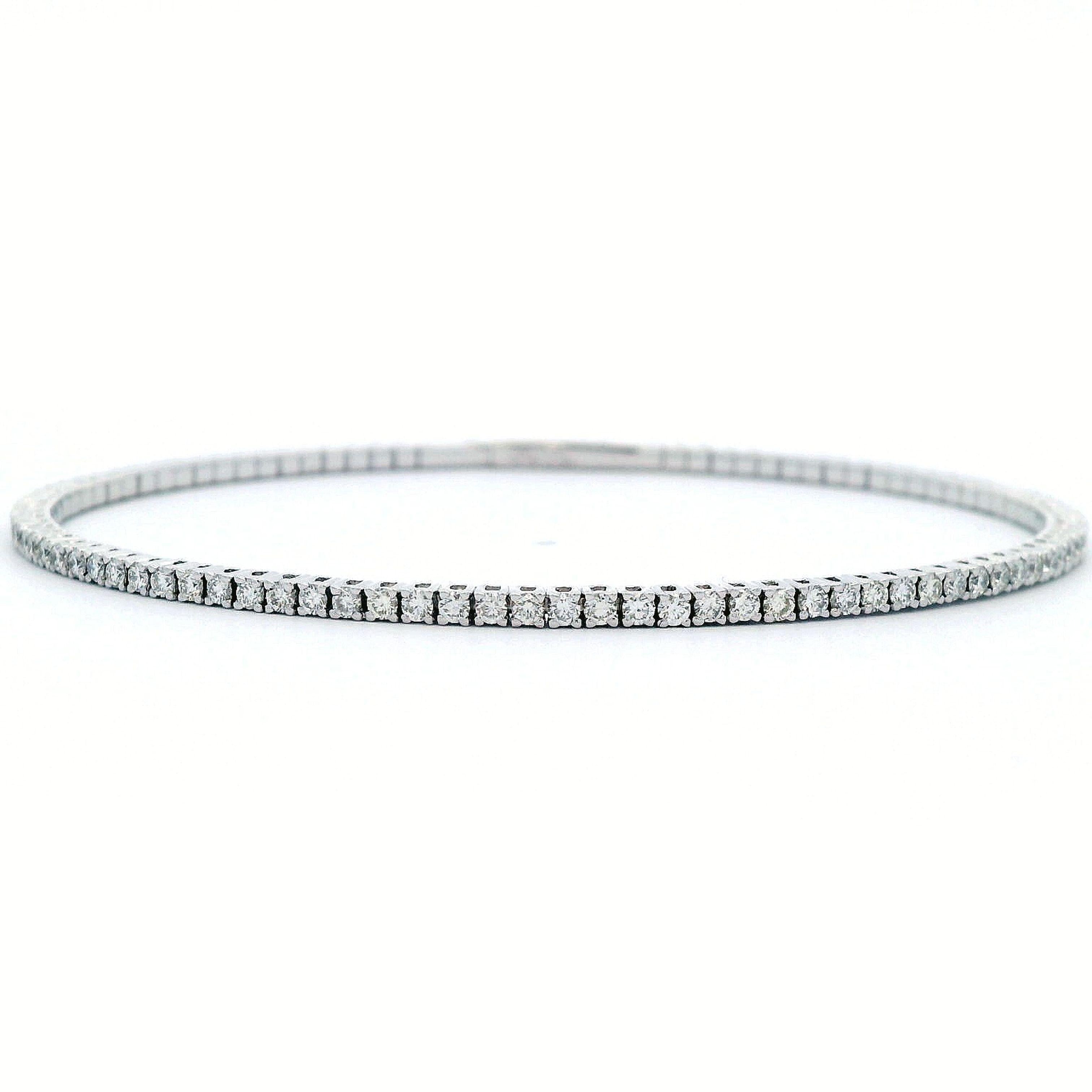 Exquisite modern diamond flexible tennis bracelet / bangle, by Alexander Beverly Hills.
93 round diamonds, 1.48 carats. Approximately F/G color and VS clarity. 14-karat white gold, 5.64 grams, 7in.
Accommodated with an up-to-date digital appraisal