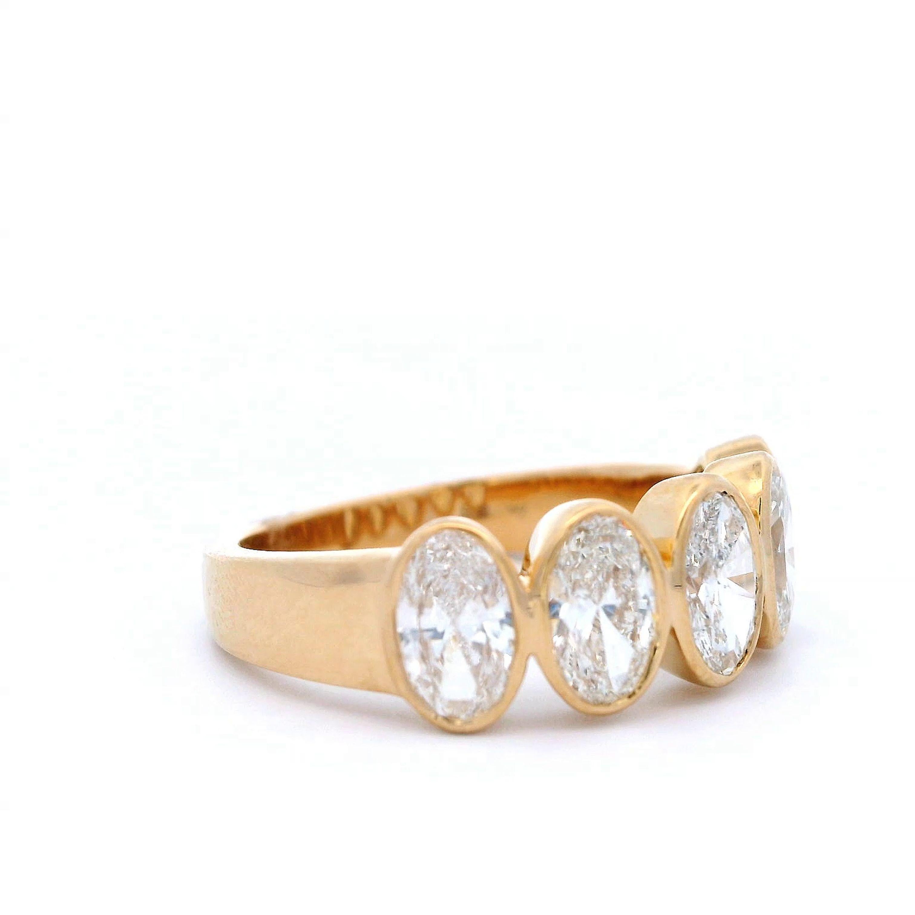 Stunning modern oval cut diamond eternity band bezel set, by Alexander Beverly Hills.
5 oval diamonds, 1.69 carats total. F/G color and SI clarity. Bezel set in 18k yellow gold, 5.87 grams, size 6.5.
Accommodated with an up to date digital appraisal