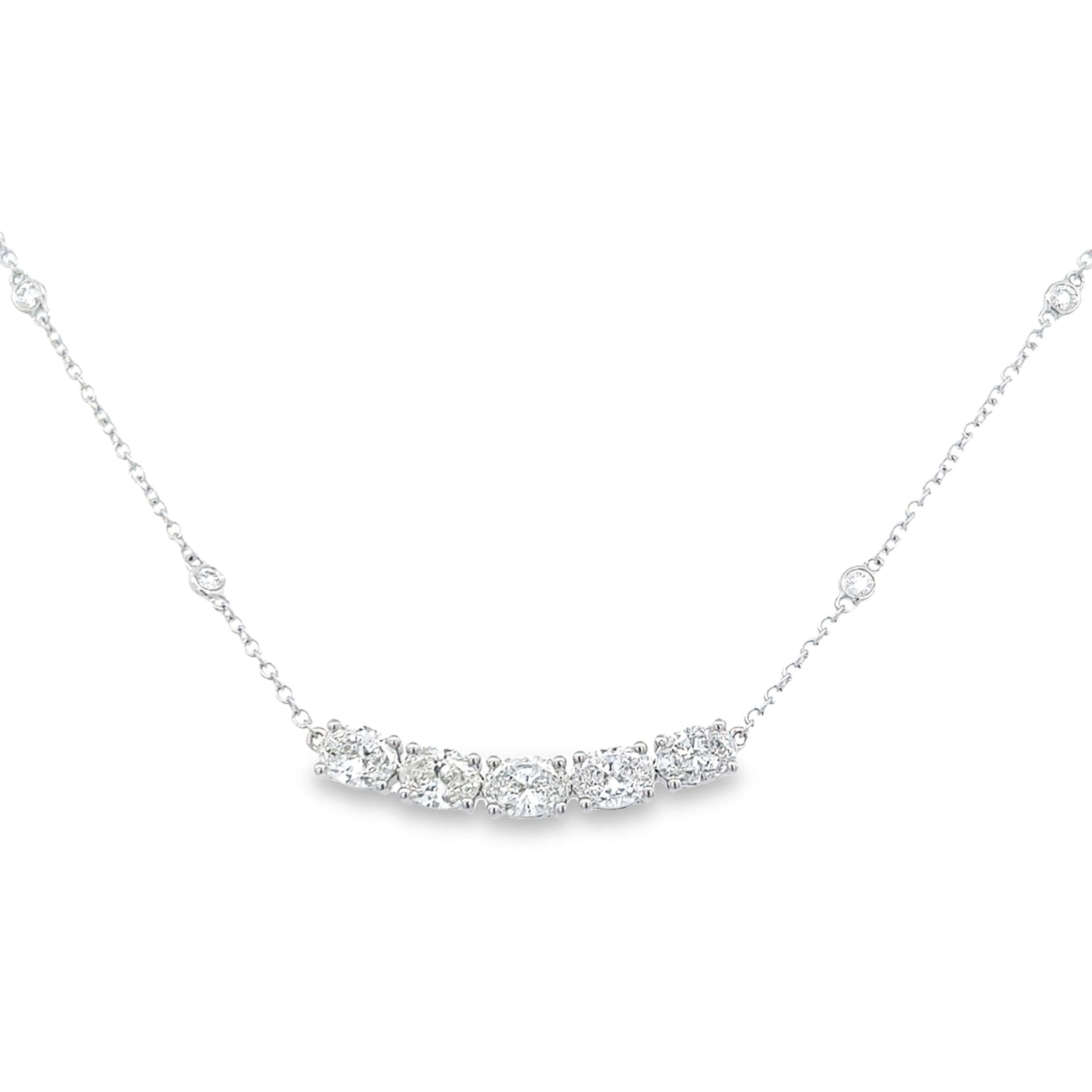 Stunning east-west oval diamond pendant necklace with diamonds by the yard chain. By Alexander Beverly Hills.
1.72 carats total diamond weight.
5 oval cut diamonds, 1.56 carats. Approximately F/G color grade and SI clarity. Complimented by 6 round