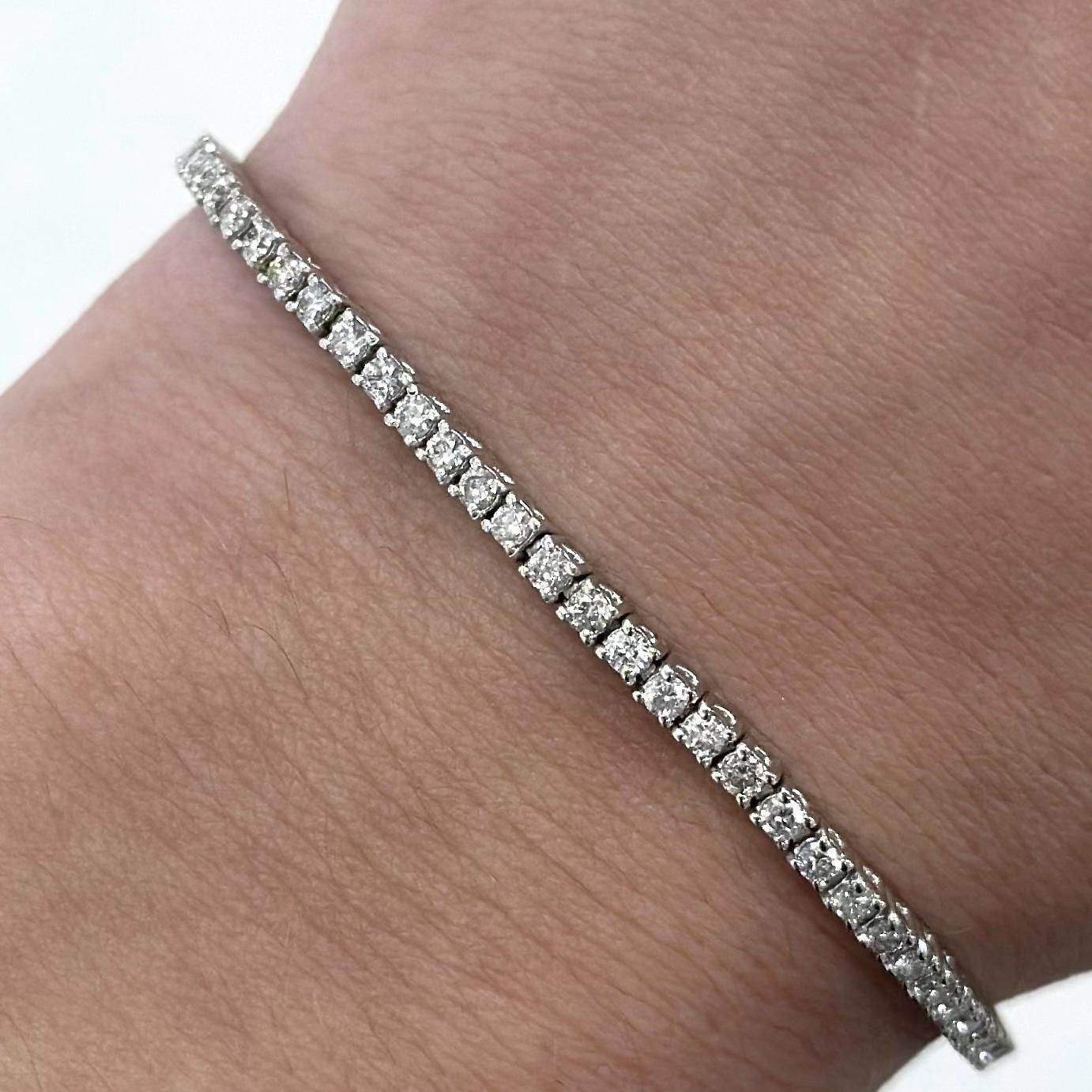 Exquisite and timeless diamonds tennis bracelet, by Alexander Beverly Hills.
81 round brilliant diamonds, 1.83 carats total. Approximately G/H color and SI2 clarity. Four prong set in 18k white gold, 7.60 grams, 7 inches.
Accommodated with an
