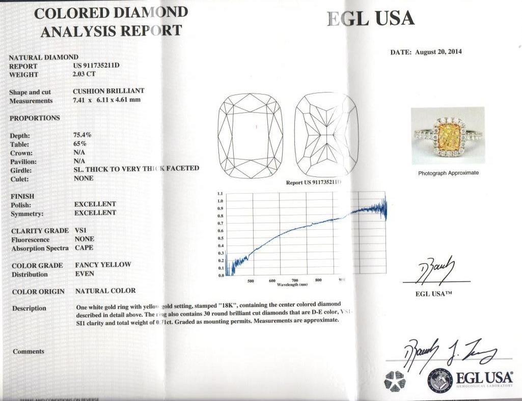 Stunning modern EGL certified yellow diamond with halo ring, two-tone 18k yellow and white gold, split shank. By Alexander Beverly Hills
2.74 carats total diamond weight.
2.03 carat cushion cut Fancy Yellow color and VS1 clarity diamond, EGL graded.