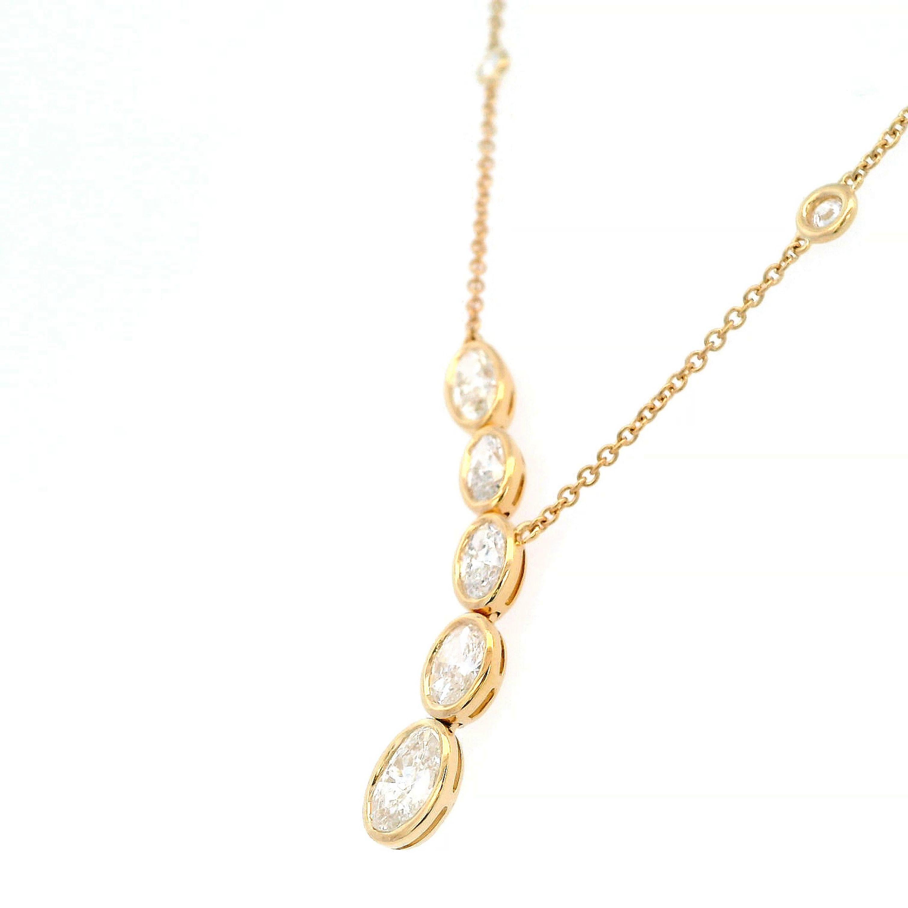 Stunning dangling bezel set oval diamond pendant necklace with diamonds by the yard chain. By Alexander Beverly Hills.
2.14 carats total diamond weight.
5 oval cut diamonds, 1.98 carats. Approximately F/G color grade and SI clarity. Complimented by