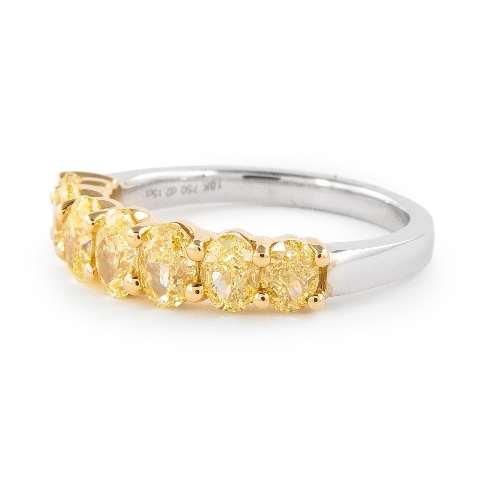 Stunning yellow oval diamond half eternity band, by Alexander Beverly Hills.
7 oval diamonds, 2.20 carats total. Approximately Fancy Yellow color and VS1 clarity. Set in 18-karat yellow and white gold, 4.06 grams, size 6.25.
Accommodated with an up