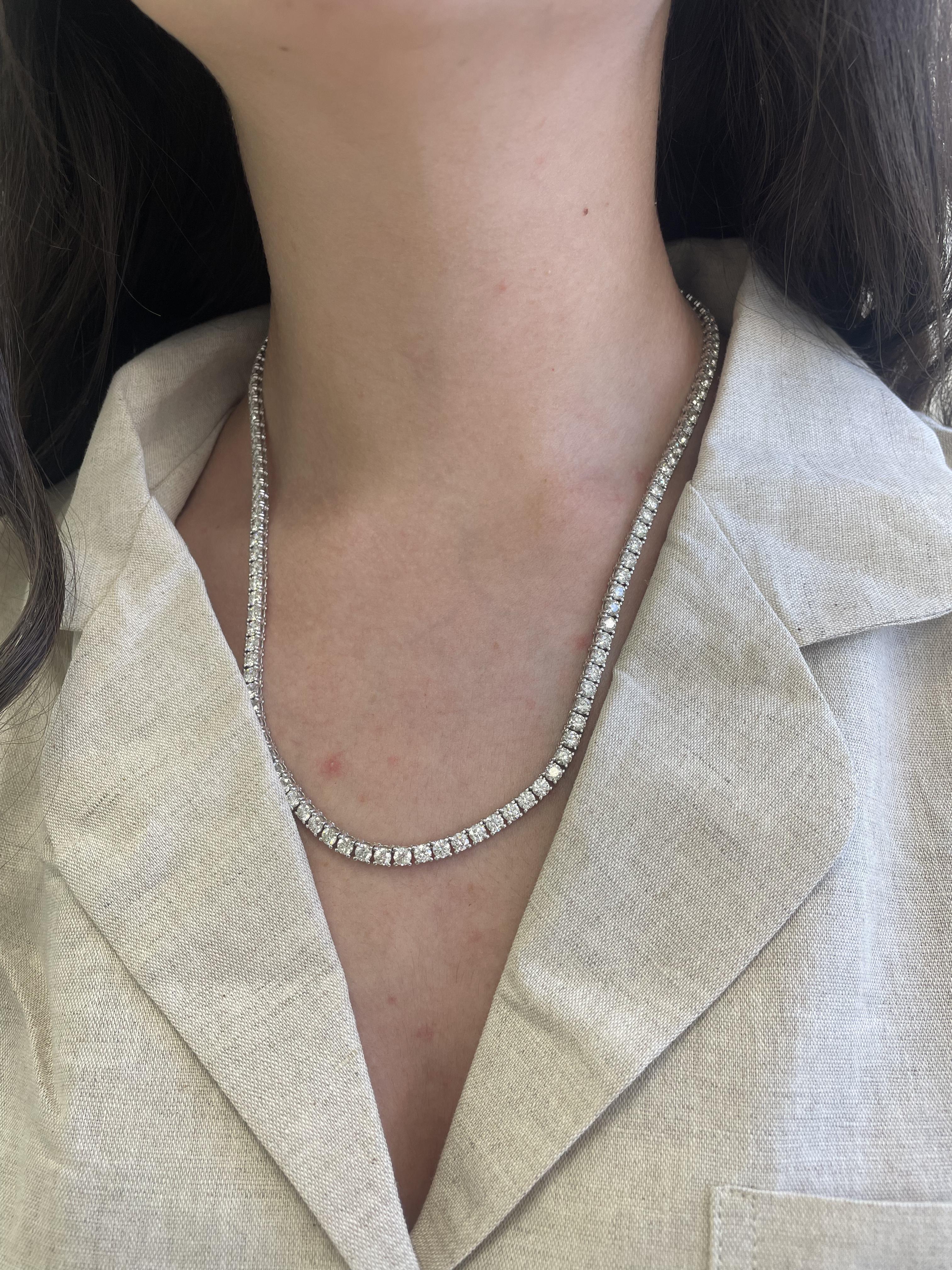 Beautiful and classic diamond tennis necklace. Created by Alexander Beverly Hills.
125 round brilliant diamonds, 23.02 carats. Approximately H/I color and VS1/VS2 clarity. 18-karat white gold, 41.29 grams, 20.25 inches.
Accommodated with an