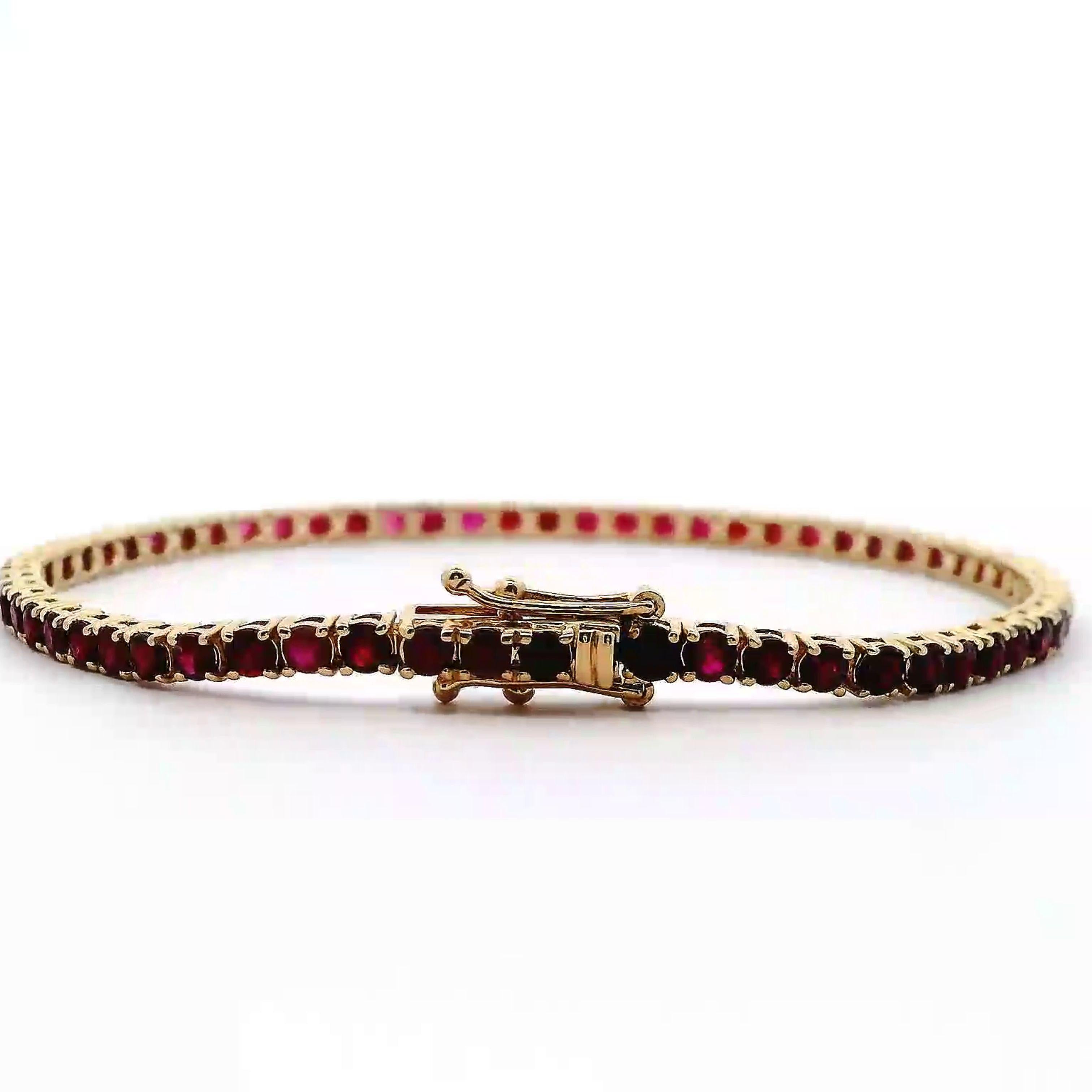 Exquisite and perfectly blended red to pink rubies and sapphires tennis bracelet, by Alexander Beverly Hills.
64 round rubies, 5.22 carats total. Four prong set in 14-karat yellow gold, 7.88 grams, 7 inches.
Accommodated with an up-to-date digital