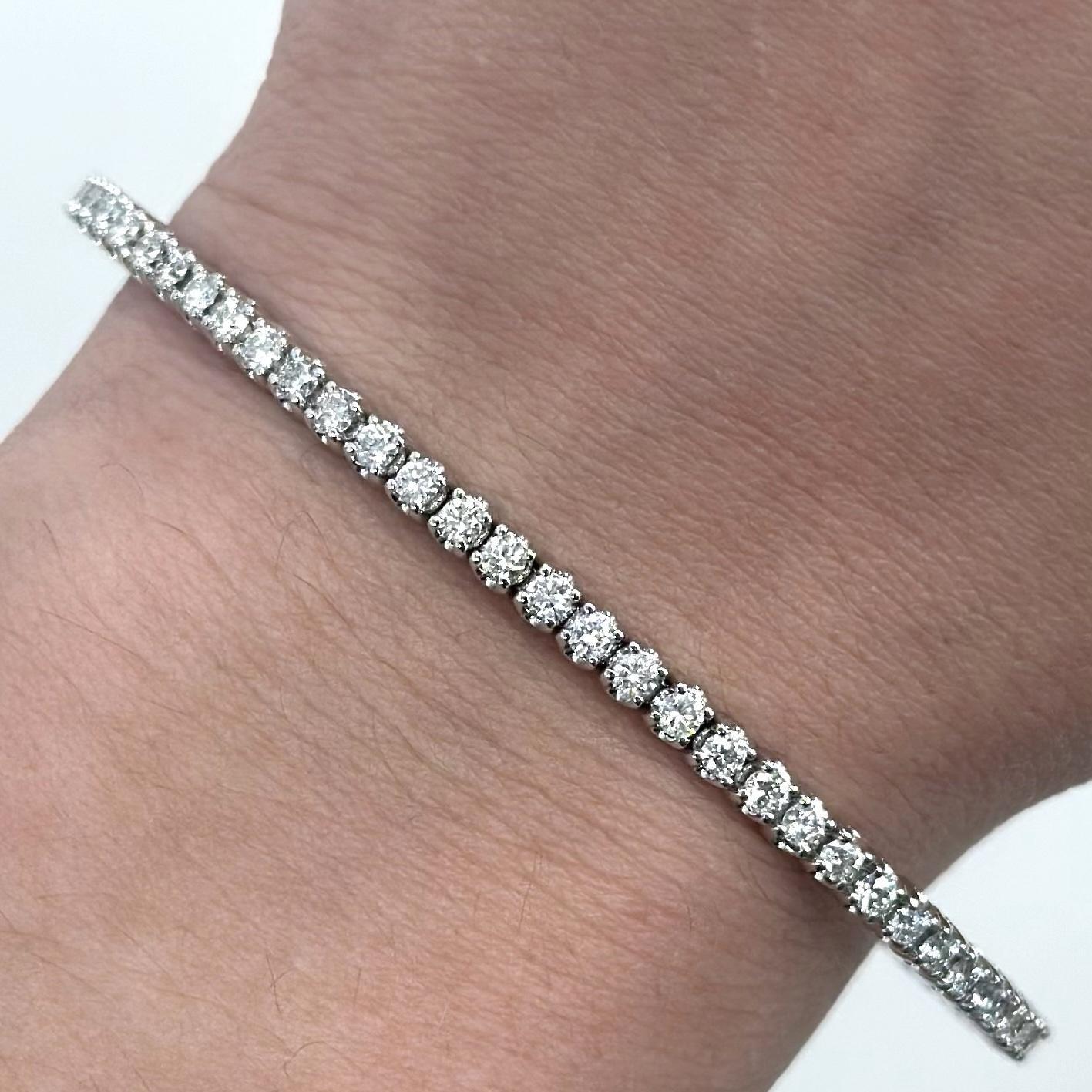 Exquisite modern diamond flexible tennis bracelet / bangle, by Alexander Beverly Hills.
64 round diamonds, 2.33 carats. Approximately E/F color and SI clarity. 14-karat white gold, 8.73 grams, 7in.
Accommodated with an up-to-date digital appraisal