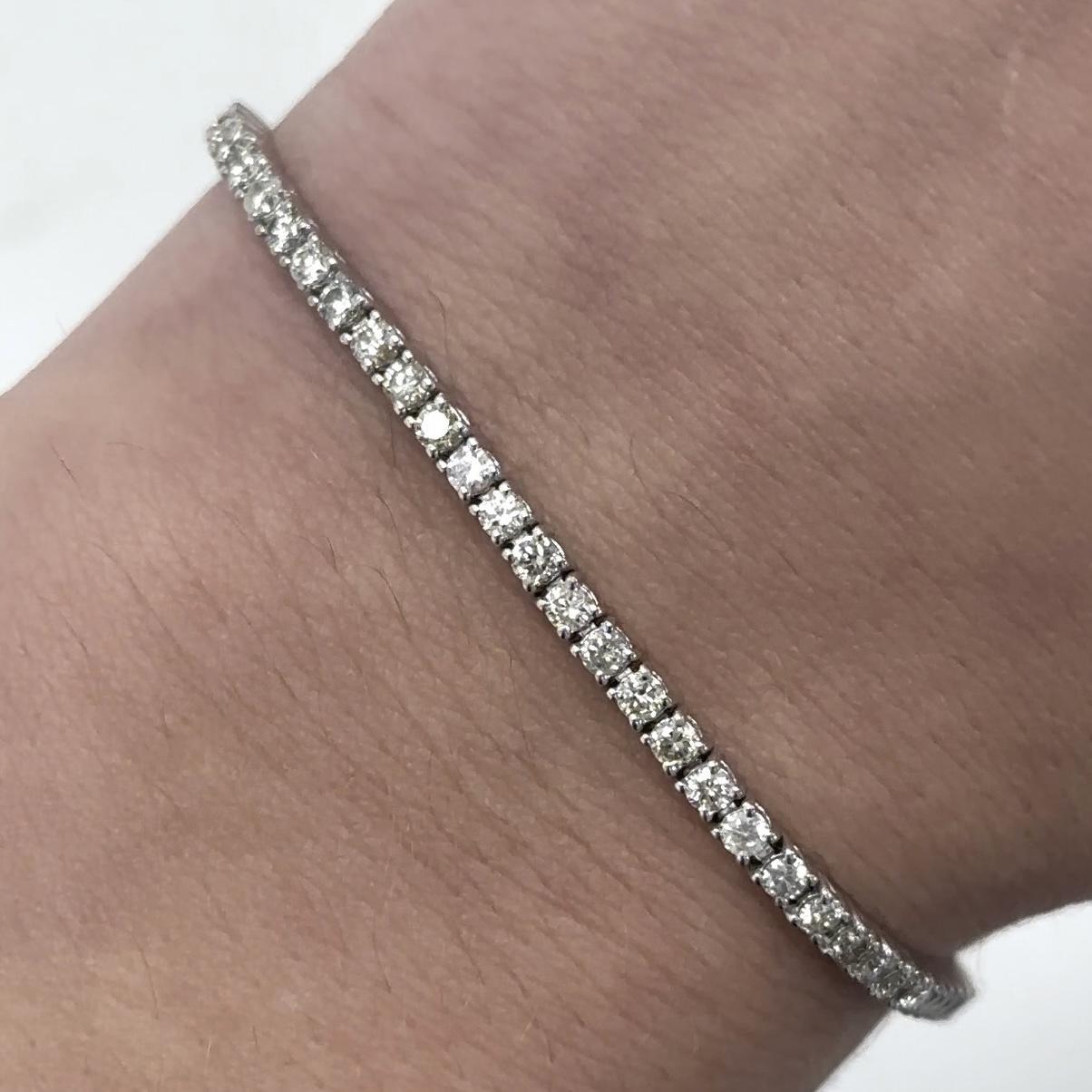 Exquisite and timeless diamonds tennis bracelet, by Alexander Beverly Hills.
75 round diamonds, 2.34 carats total. Approximately J-L color and SI clarity. Four prong set in 18k white gold, 7.53 grams, 7 inches.
Accommodated with an up-to-date