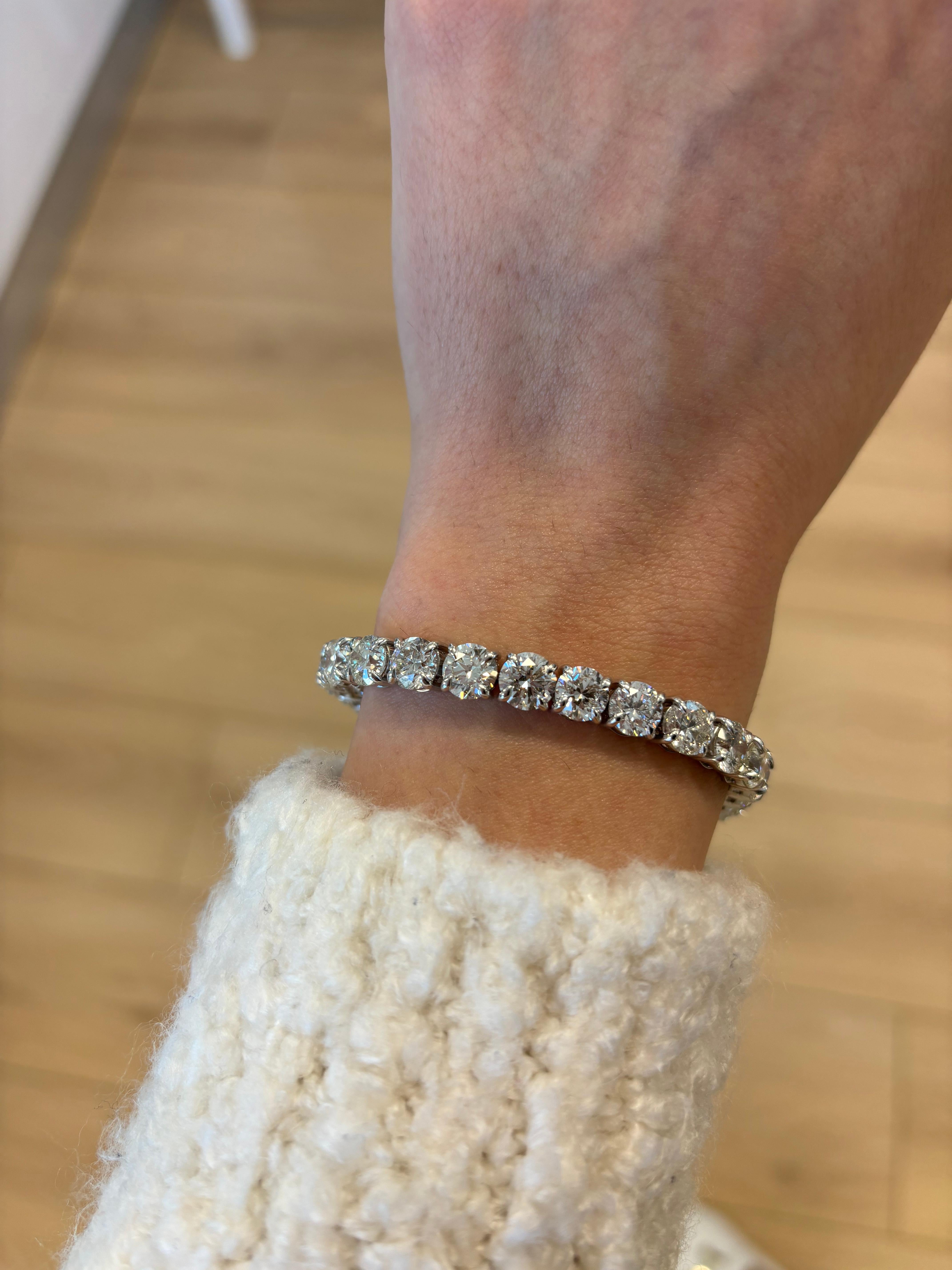 Exquisite and timeless diamonds tennis bracelet, by Alexander Beverly Hills.
28 round brilliant diamonds, 27.87 carats. Approximately H/I color and SI clarity. Four prong set in 18k white gold, 24.92 grams, 7 inches. 
Accommodated with an up-to-date