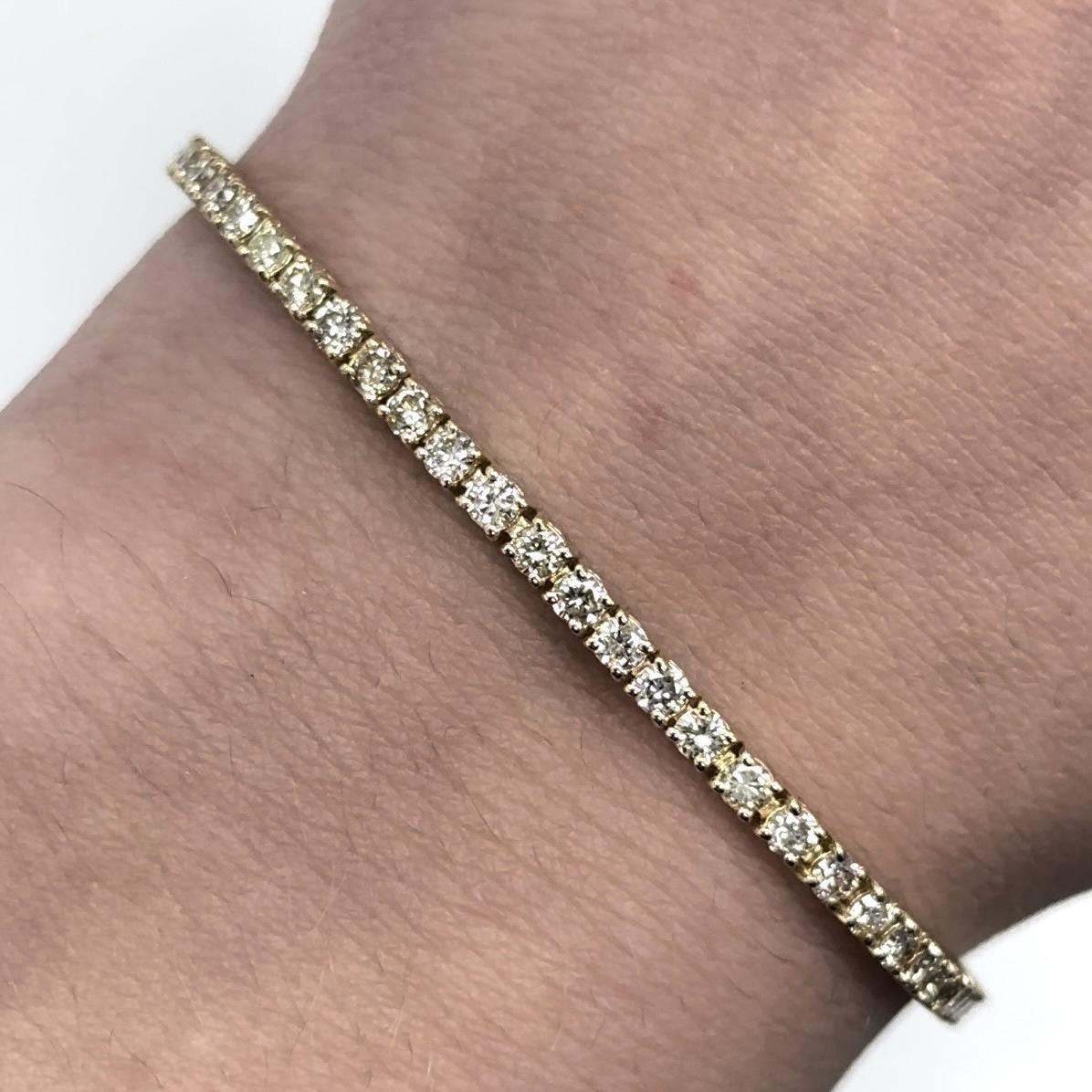 Exquisite and timeless diamonds tennis bracelet, by Alexander Beverly Hills.
69 round diamonds, 3.09 carats total. Approximately J-L color and SI clarity. Four prong set in 18k yellow gold, 8.27 grams, 7 inches.
Accommodated with an up-to-date