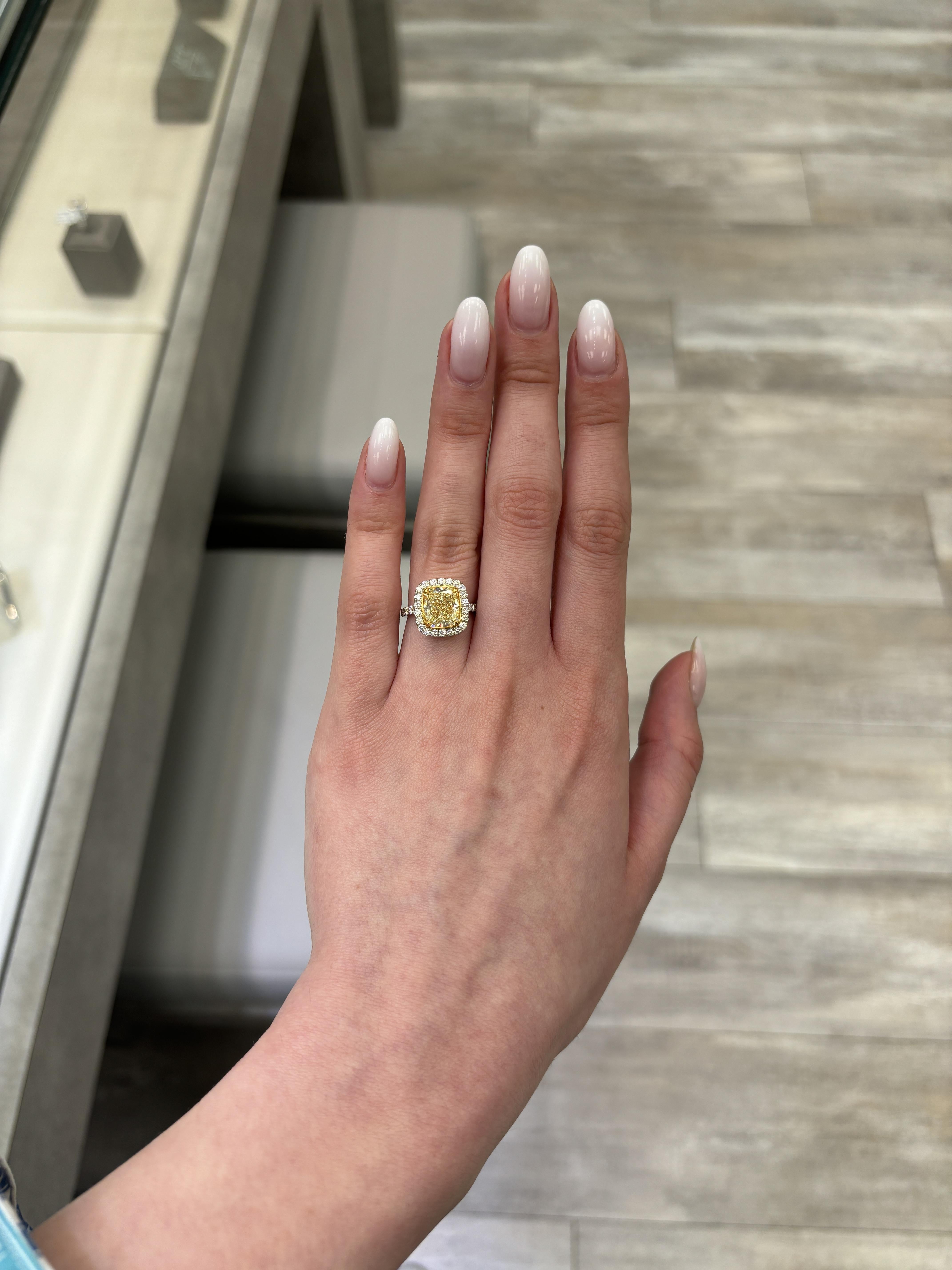 Stunning modern EGL certified fancy yellow diamond with diamond halo ring, two-tone 18k white and yellow gold.
High jewelry by Alexander Beverly Hills.
4.00 carats total diamond weight.
3.30 carat cushion Fancy Yellow color and VS2 clarity diamond,