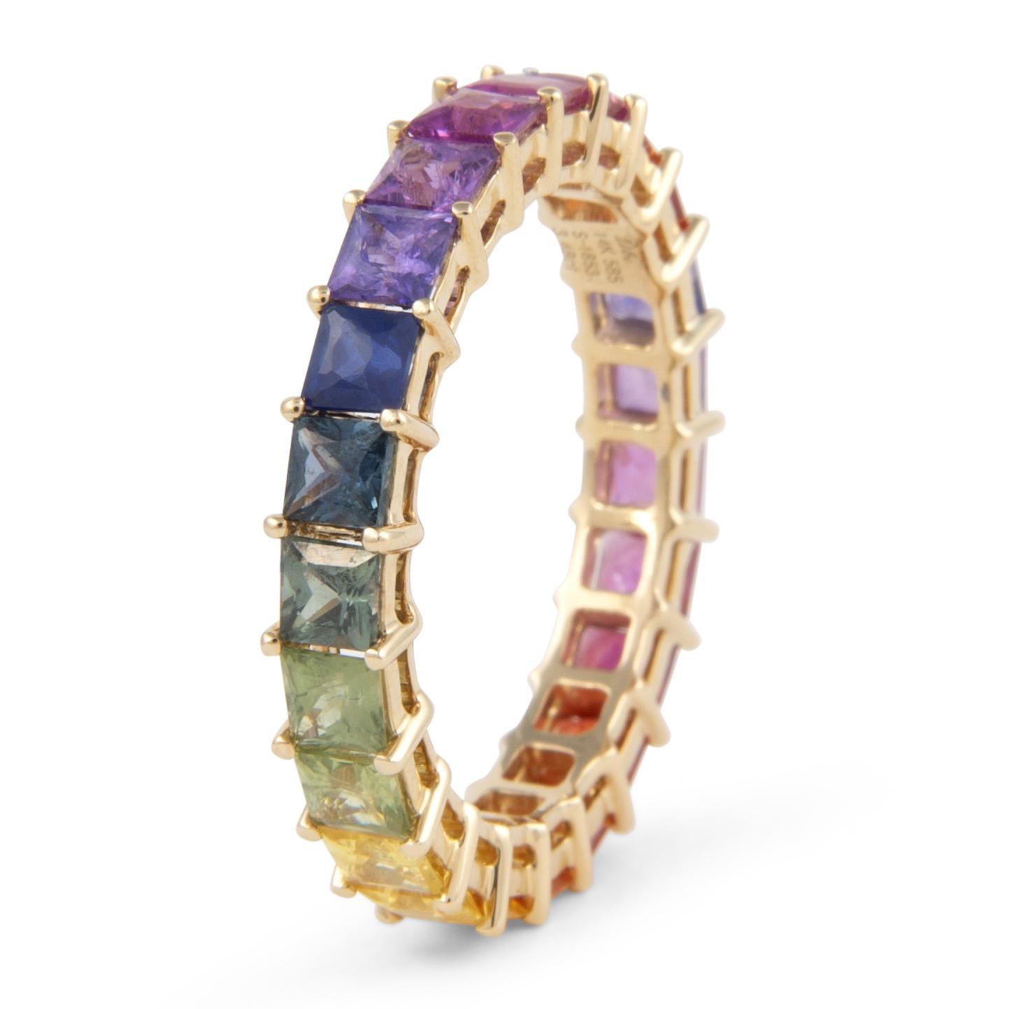 Modern rainbow sapphire eternity band. By Alexander Beverly Hills.
23 princess cut multi color sapphires, heat, 3.48 carats. Prong set in 14-karat yellow gold, 2.89g, ring size 6.5.
Accommodated with an up-to-date digital appraisal by a GIA G.G.