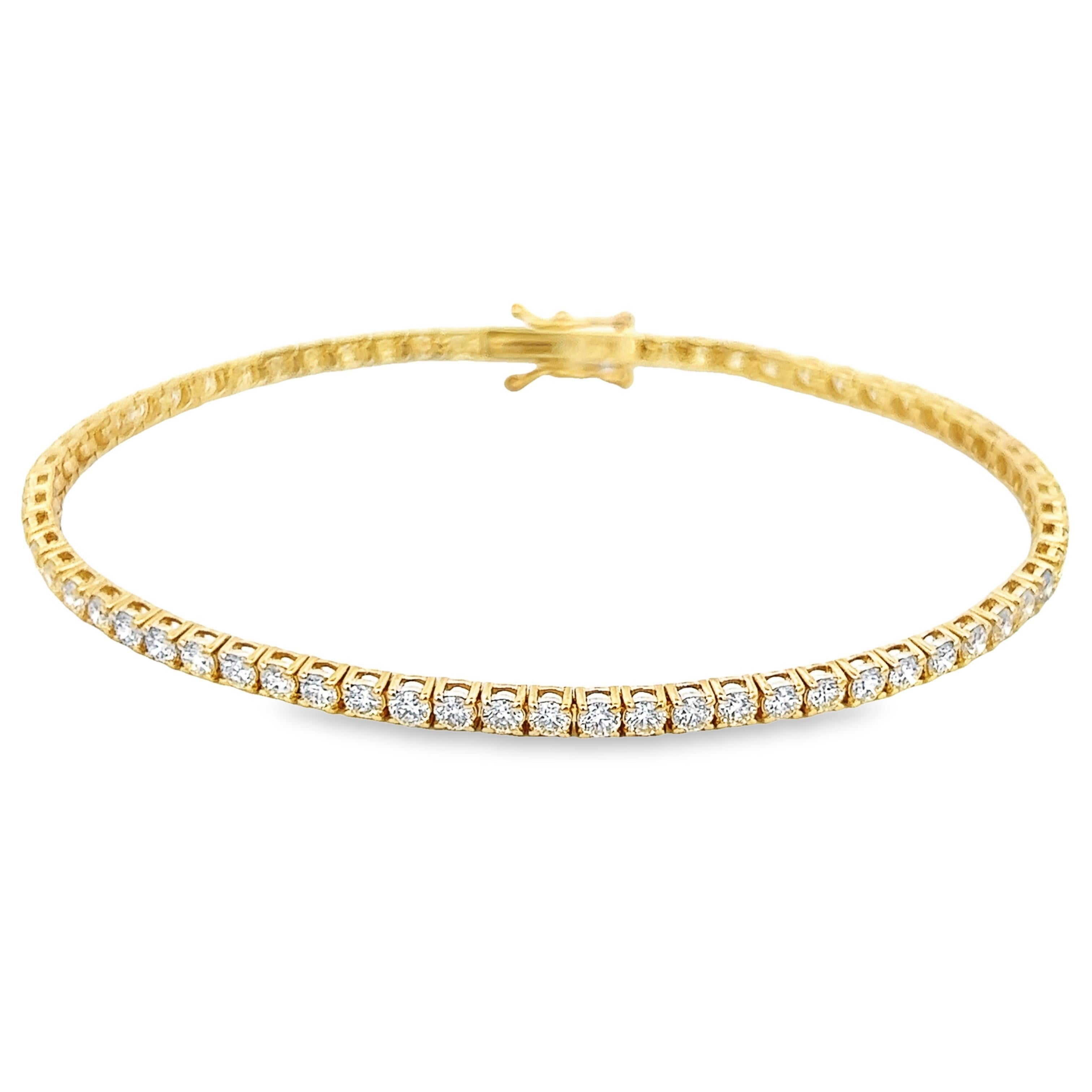 Exquisite and timeless diamonds tennis bracelet, by Alexander Beverly Hills.
66 round brilliant diamonds, 3.57 carats total. Approximately H/I color and VS clarity. Four prong set in 14k yellow gold, 6.92 grams, 7 inches.
Accommodated with an up to