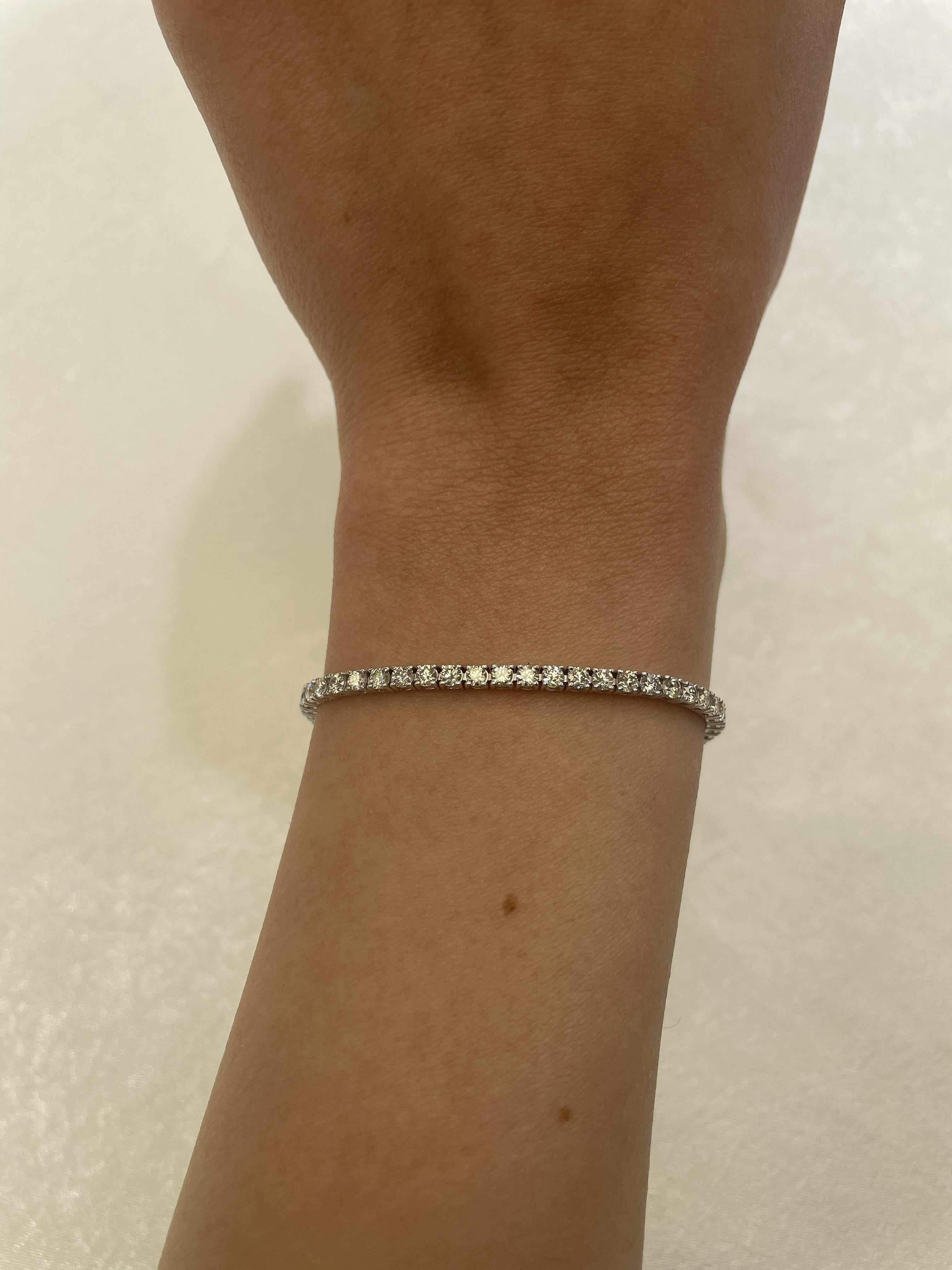 Exquisite and timeless diamonds tennis bracelet, by Alexander Beverly Hills.
65 round brilliant diamonds, 3.96 carats total. Approximately G color and VS clarity. Four prong set in 18k white gold, 8.20 grams, 7 inches. 
Accommodated with an