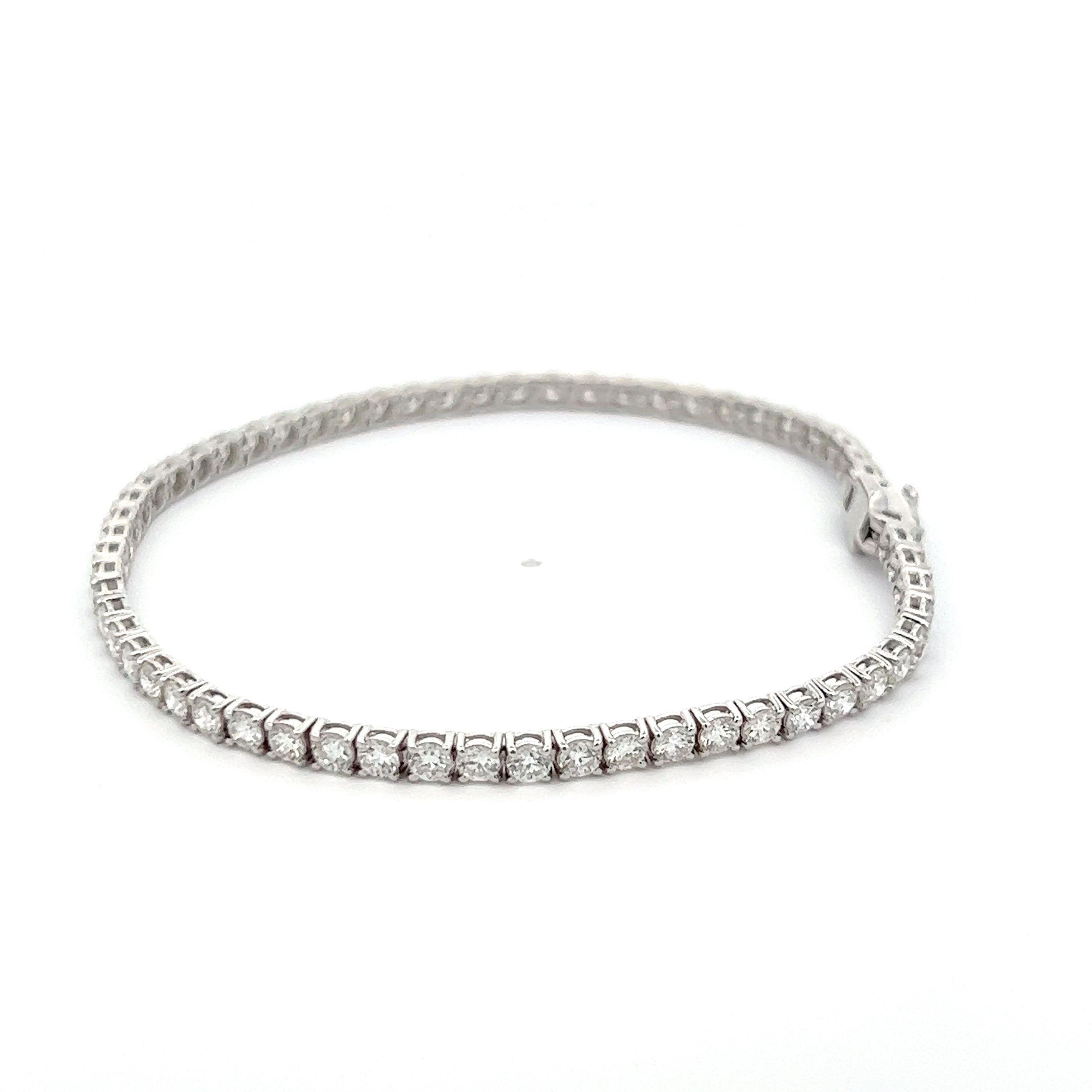 Exquisite and timeless diamonds tennis bracelet, by Alexander Beverly Hills.
61 round brilliant diamonds, 4.15 carats. Approximately E/F color and VS clarity. Four prong set in 14k white gold, 6.10 grams, 7 inches.
Accommodated with an up to date