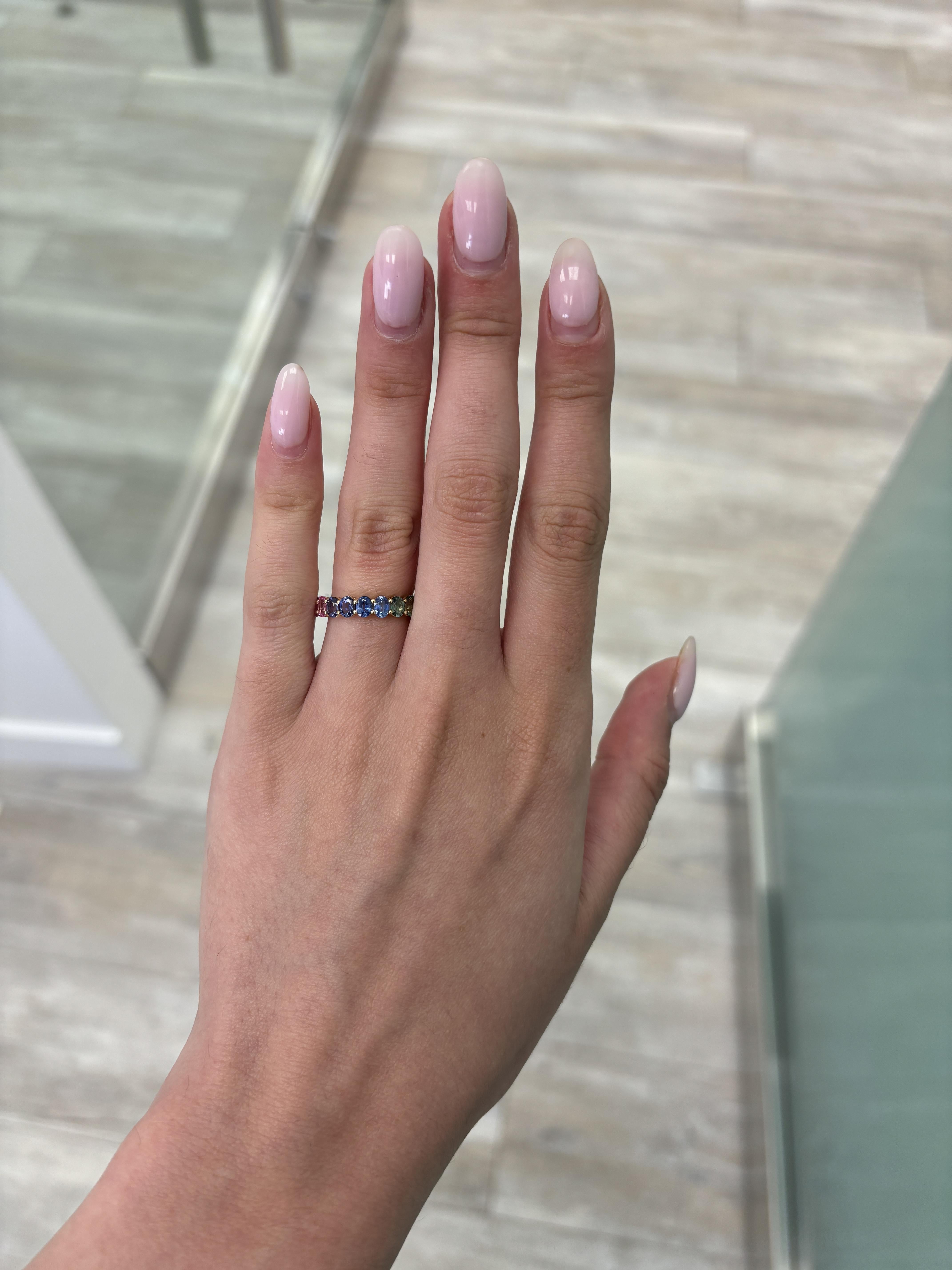 Modern rainbow sapphire eternity band. By Alexander Beverly Hills.
20 oval cut multi color sapphires, heat, 4.16 carats. Prong set in 14-karat yellow gold, 2.75g, ring size 5.
Accommodated with an up-to-date digital appraisal by a GIA G.G. once