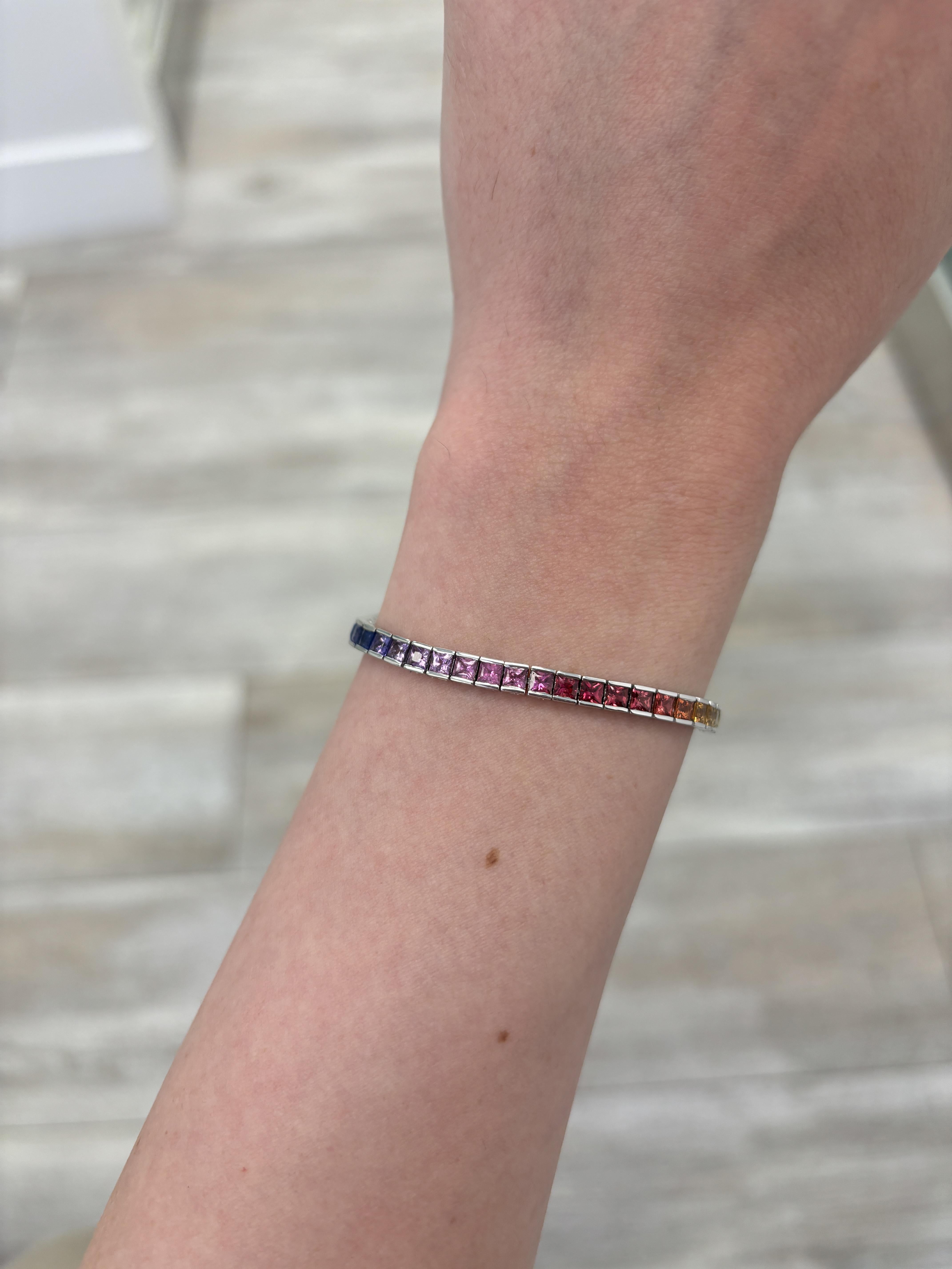 Exquisite and perfectly graduated rainbow multi color sapphire adjustable bracelet, by Alexander Beverly Hills.
27 princess cut sapphires, 4.18 carats total. 14k white gold, 6.57 grams, 7.5 inches.
Accommodated with an up-to-date digital appraisal