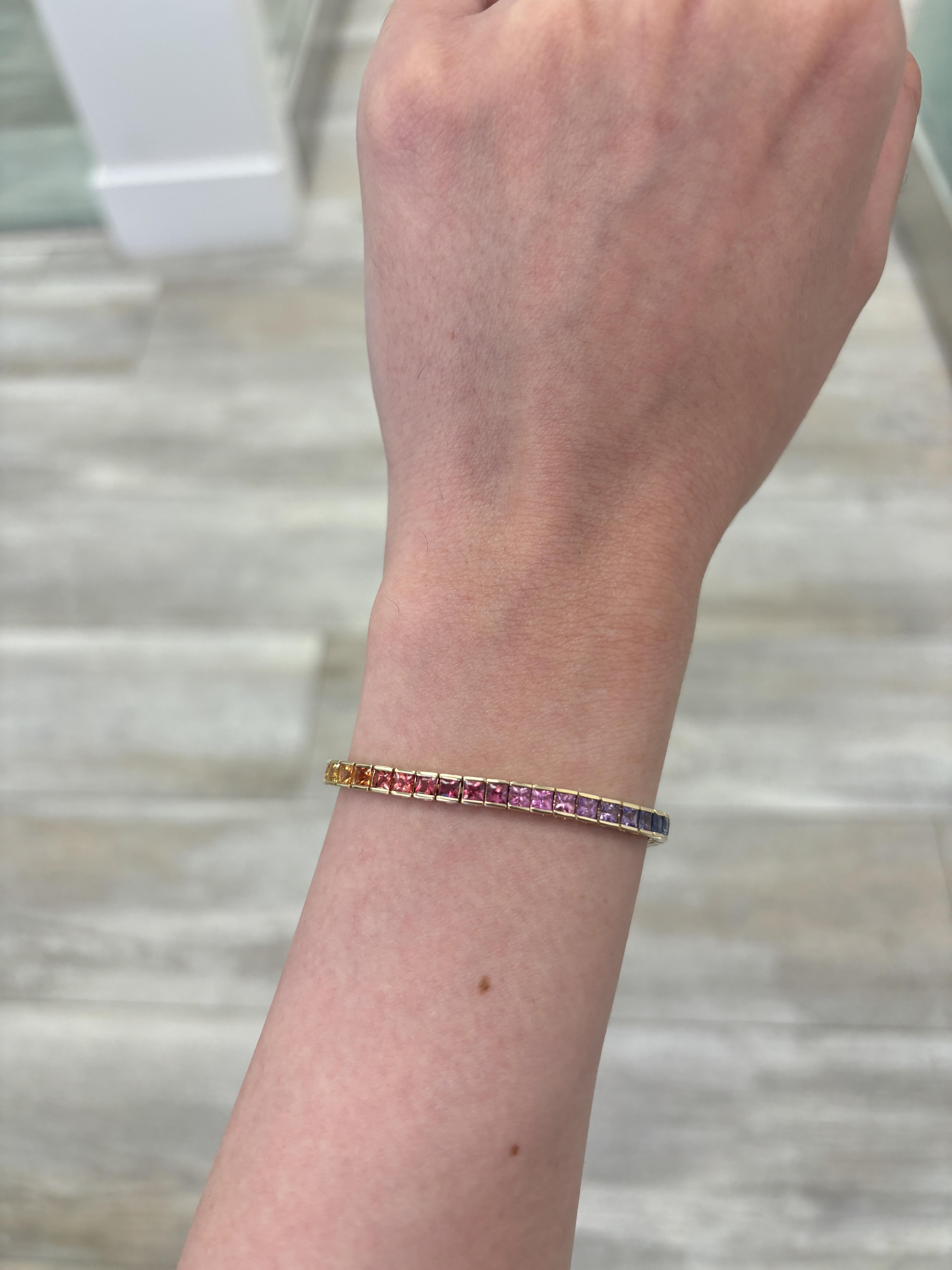 Exquisite and perfectly graduated rainbow multi color sapphire adjustable bracelet, by Alexander Beverly Hills.
29 princess cut sapphires, 4.42 carats total. 14k yellow gold, 7.00 grams, 7.5 inches.
Accommodated with an up-to-date digital appraisal