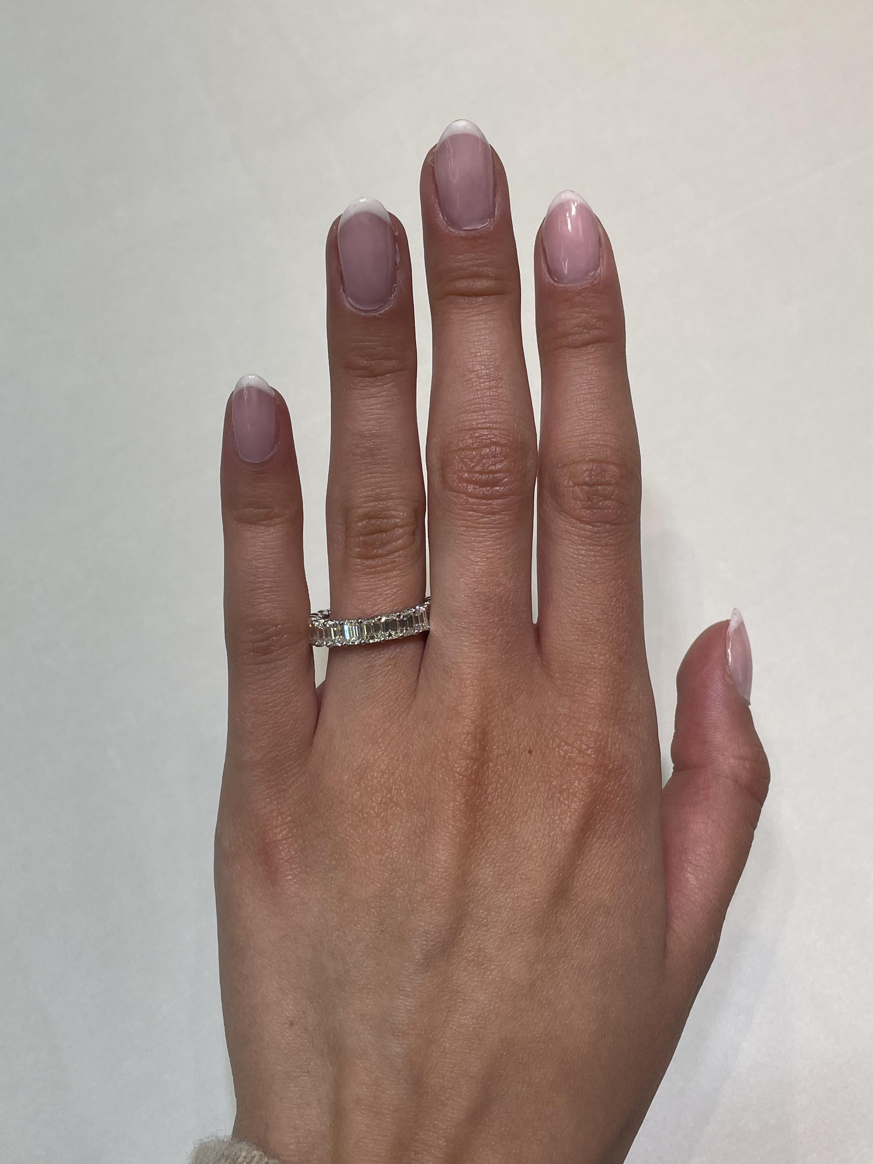 Stunning emerald cut diamond eternity band, by Alexander Beverly Hills.
22 emerald cut diamonds, 4.68 carats total. Approximately H/I color and VS1 clarity. 4 prong set in 18-karat white gold, 3.60 grams, size 6.25.
Accommodated with an up to date