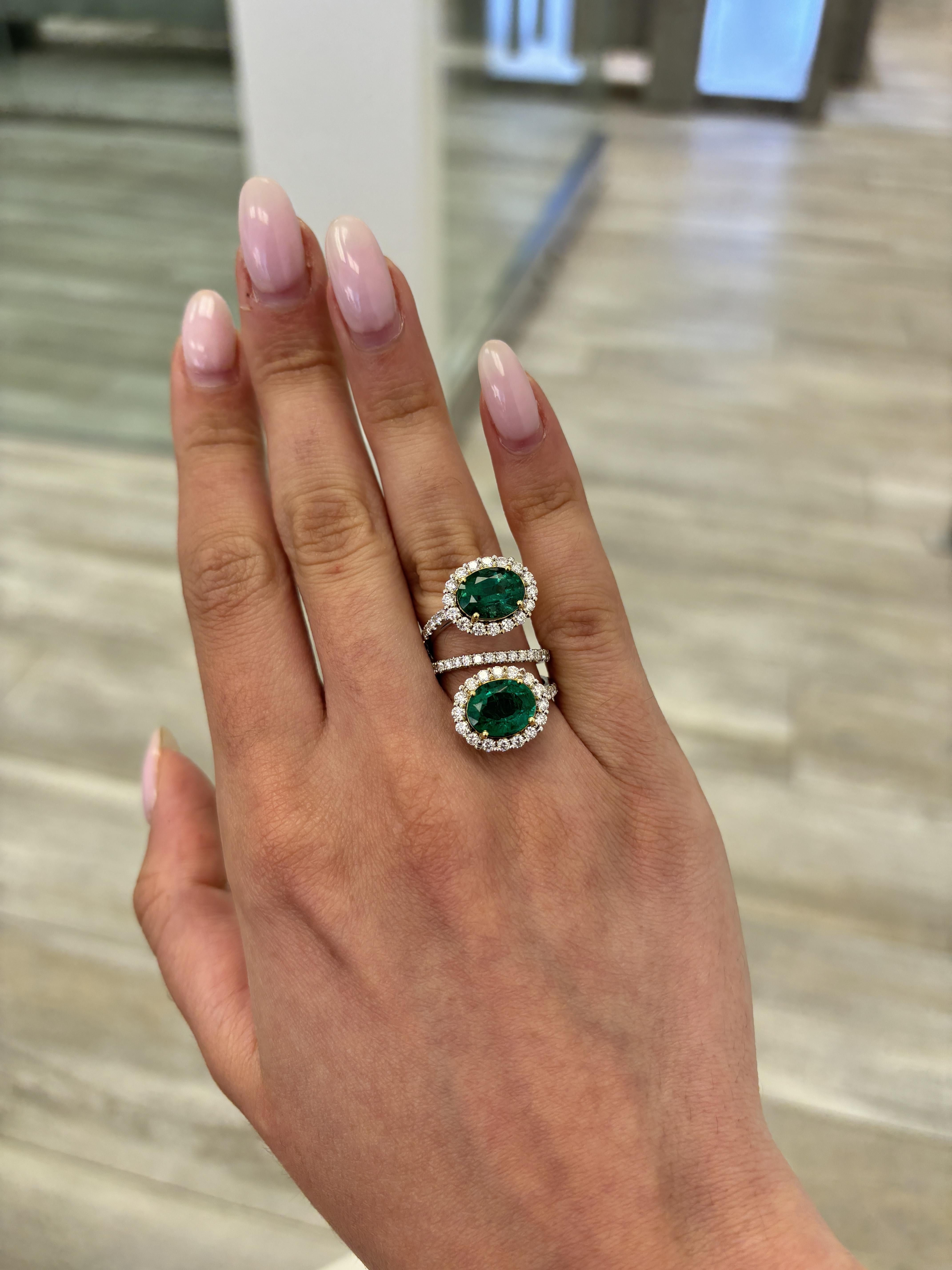 Stunning modern floating emerald and diamond toi et moi bypass ring. High jewelry by Alexander Beverly Hills.
6.60 carats total diamond weight.
2 oval emeralds, 4.79 carats apx F2. Complimented with 80 round brilliant diamonds, 1.81 carats.