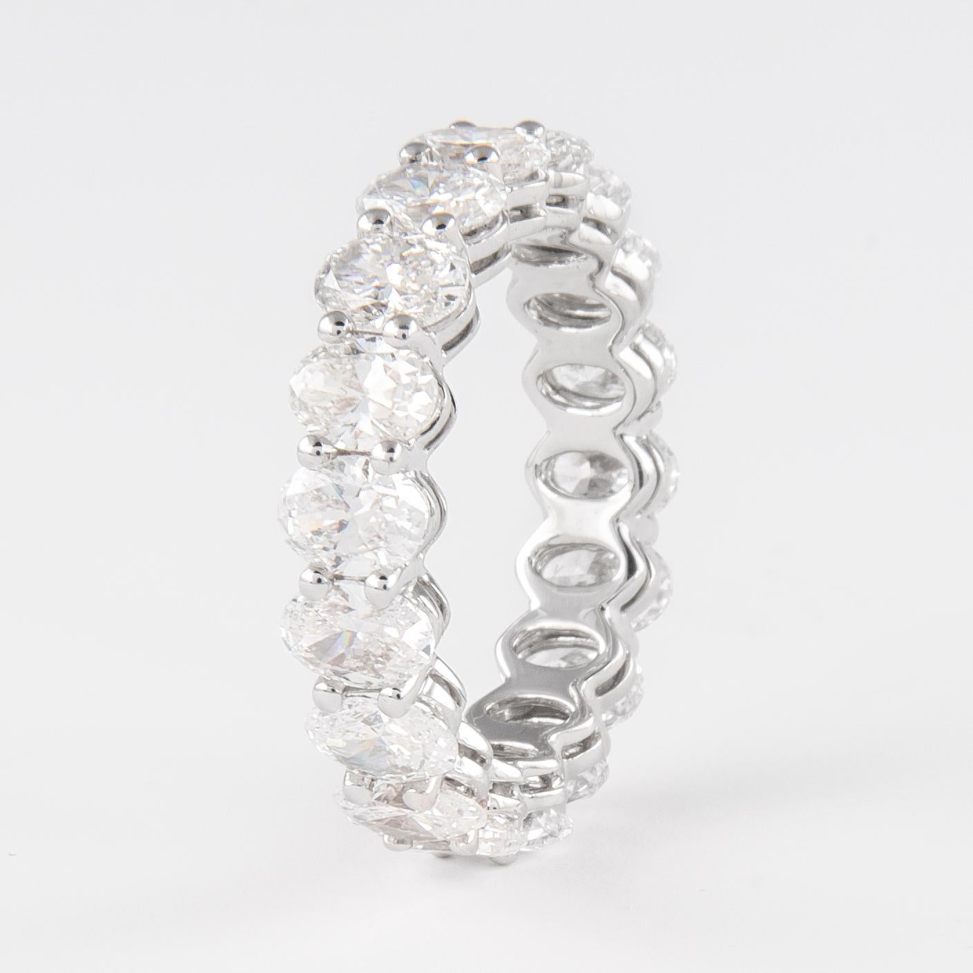 Stunning oval cut diamond eternity band, by Alexander Beverly Hills.
18 oval brilliant cut diamonds, 4.98 carats total. Approximately F/G color and VS clarity. Set in platinum, 5.89 grams, size 7.5. 
Accommodated with an up-to-date digital appraisal