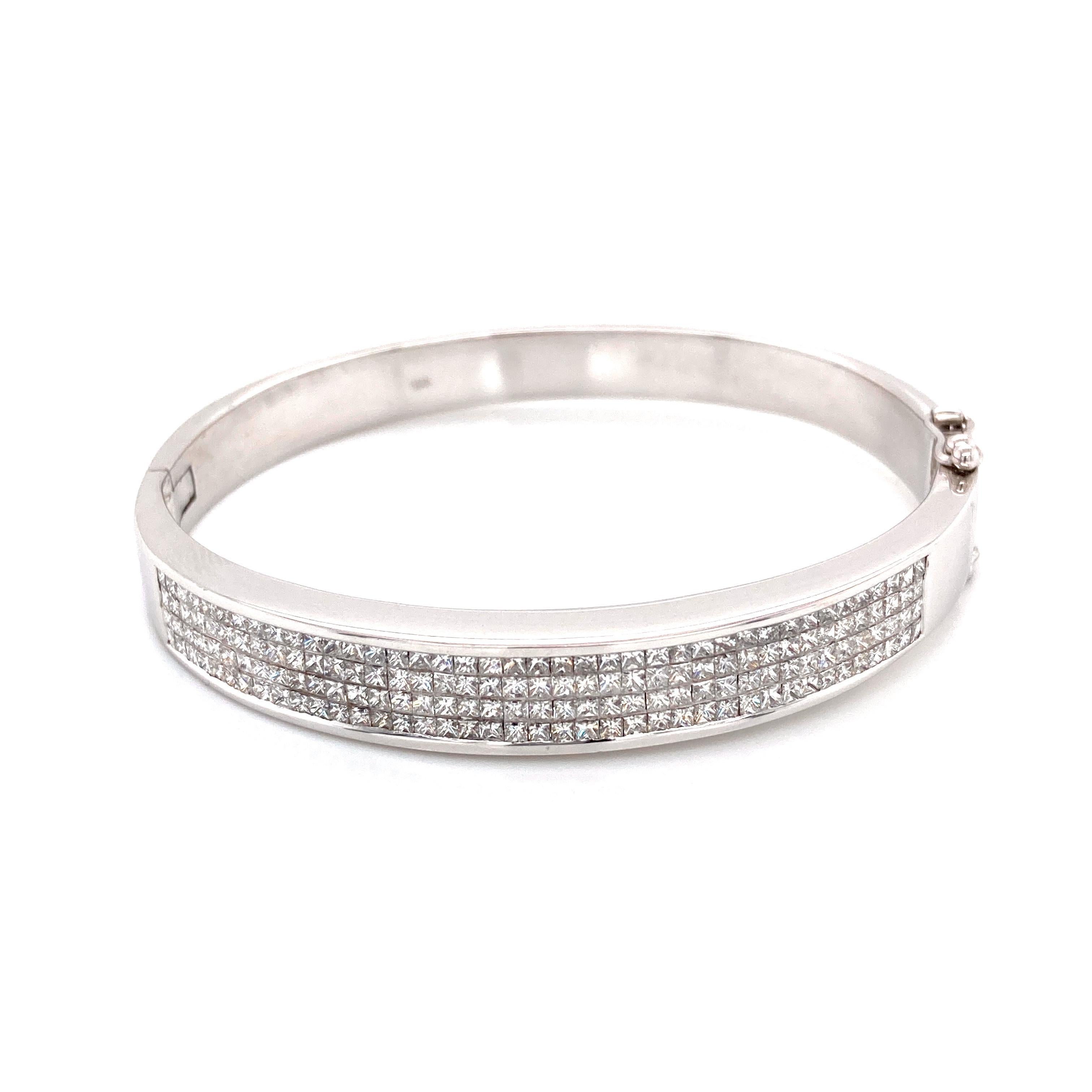 Modern princess cut diamond bangle, by Alexander Beverly Hills.
160 princess cut diamonds, 5.0 carats. Approximately F/G color and VS clarity. 18-karat white gold, 26.27 grams, 6in.
Accommodated with an up-to-date digital appraisal by a GIA G.G.