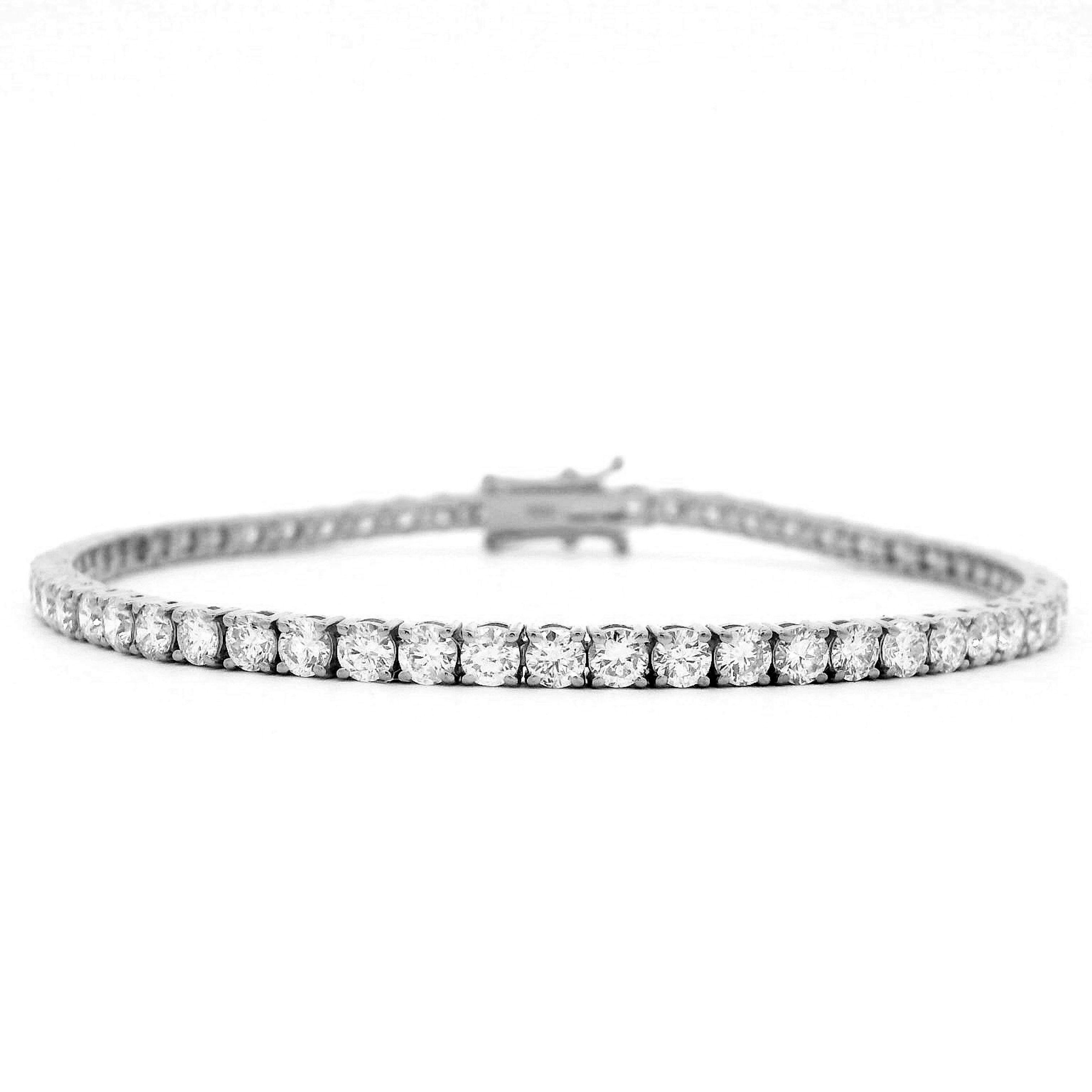 Exquisite and timeless illusion set diamonds tennis bracelet, by Alexander Beverly Hills.
62 round brilliant diamonds, 5.16 carats total. Approximately D-F color and SI clarity. Four prong set in 18k white gold, 9.42 grams, 7 inches. 
Accommodated