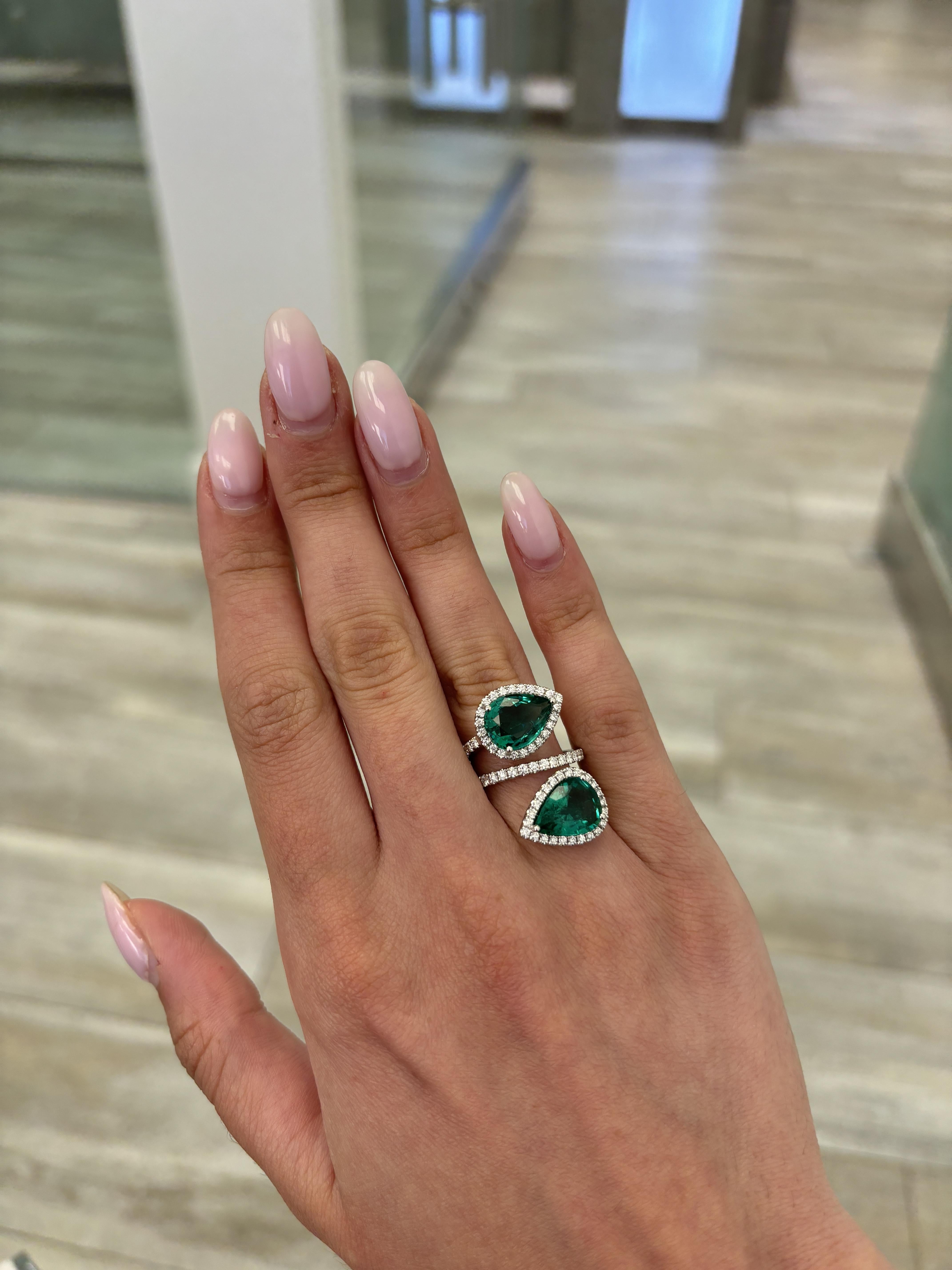 Stunning modern floating emerald and diamond toi et moi bypass ring. High jewelry by Alexander Beverly Hills.
6.38 carats total diamond weight.
2 pear emeralds, 5.21 carats apx F1/F2. Complimented with 91 round brilliant diamonds, 1.17 carats.