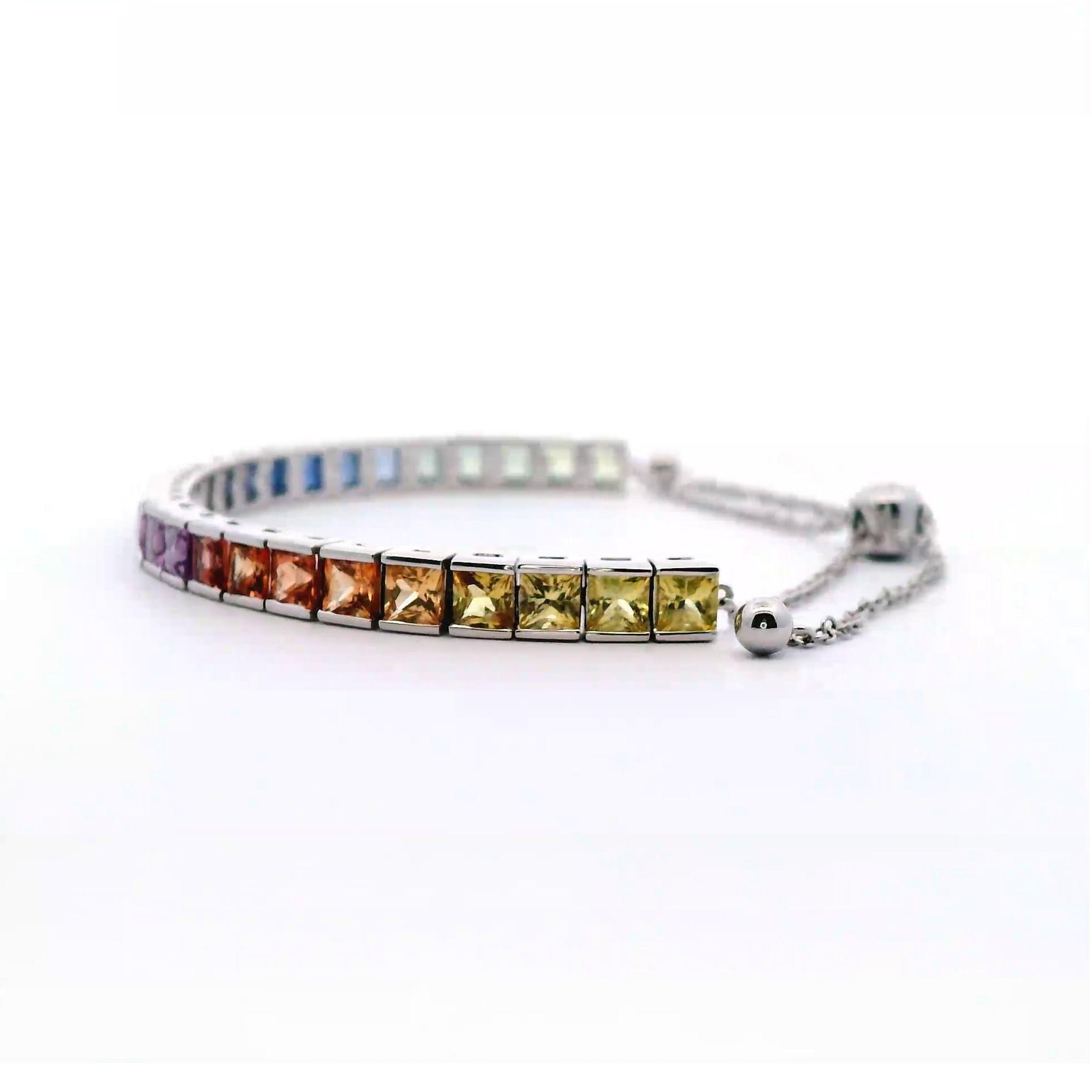 Exquisite and perfectly graduated rainbow multi color sapphire adjustable bracelet, by Alexander Beverly Hills.
27 princess cut sapphires, 6.06 carats total. 14k white gold, 8.26 grams, 7.5 inches.
Accommodated with an up-to-date digital appraisal