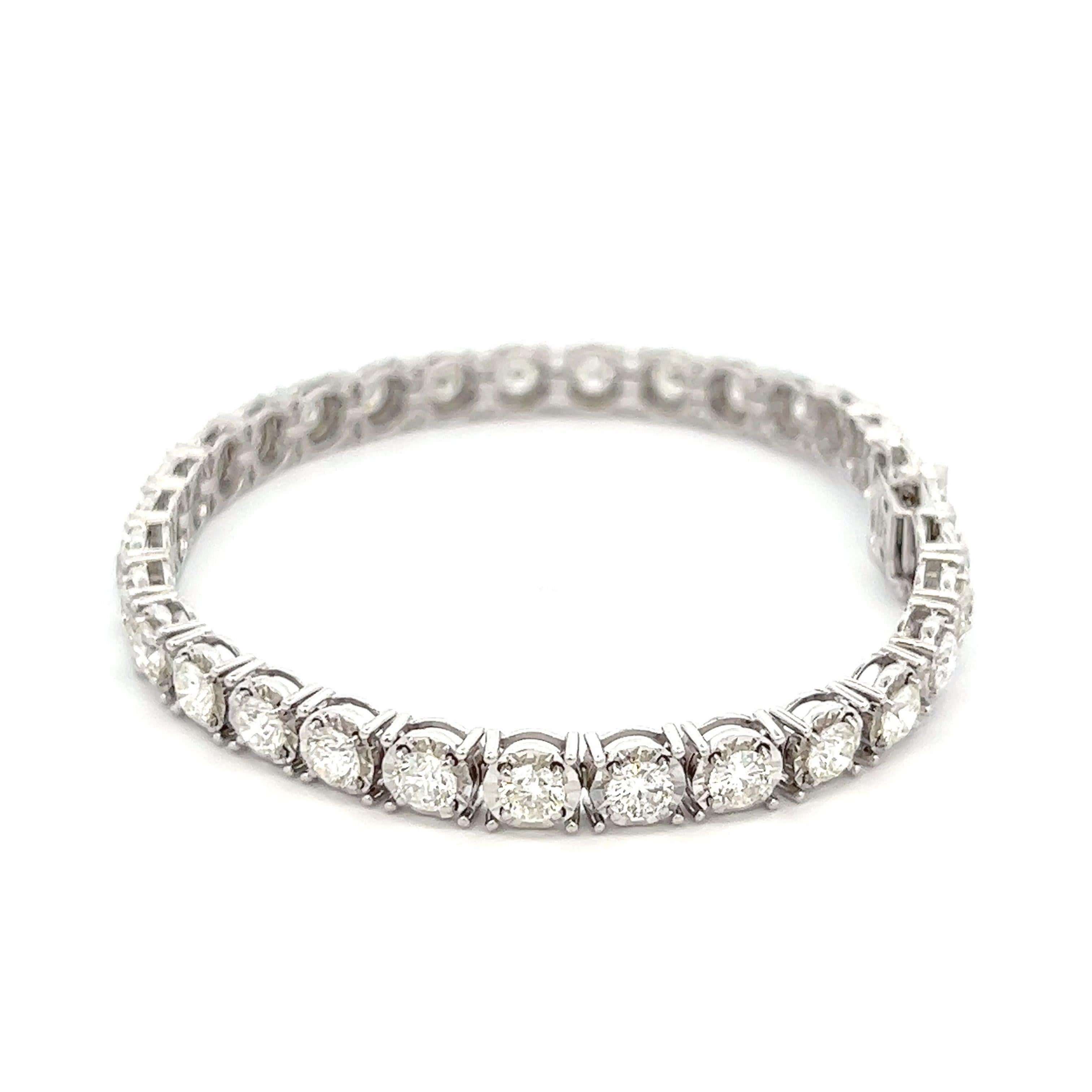 Exquisite and timeless illusion set diamonds tennis bracelet, by Alexander Beverly Hills.
31 round brilliant diamonds, 6.84 carats total. Approximately H-I color and VS1-SI1 clarity. Four prong set in 18k white gold, 16.98 grams, 7 inches.