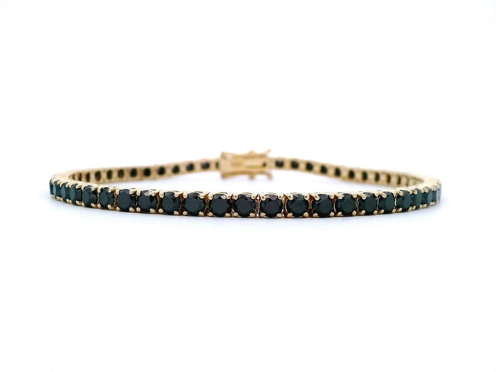 Stunning modern natural black diamond tennis bracelet. High jewelry by Alexander Beverly Hills.
57 round black diamonds, 7.06 carats. 14-karat yellow gold, 9.15 grams, 7.25 inches.
Accommodated with an up-to-date digital appraisal by a GIA G.G. once