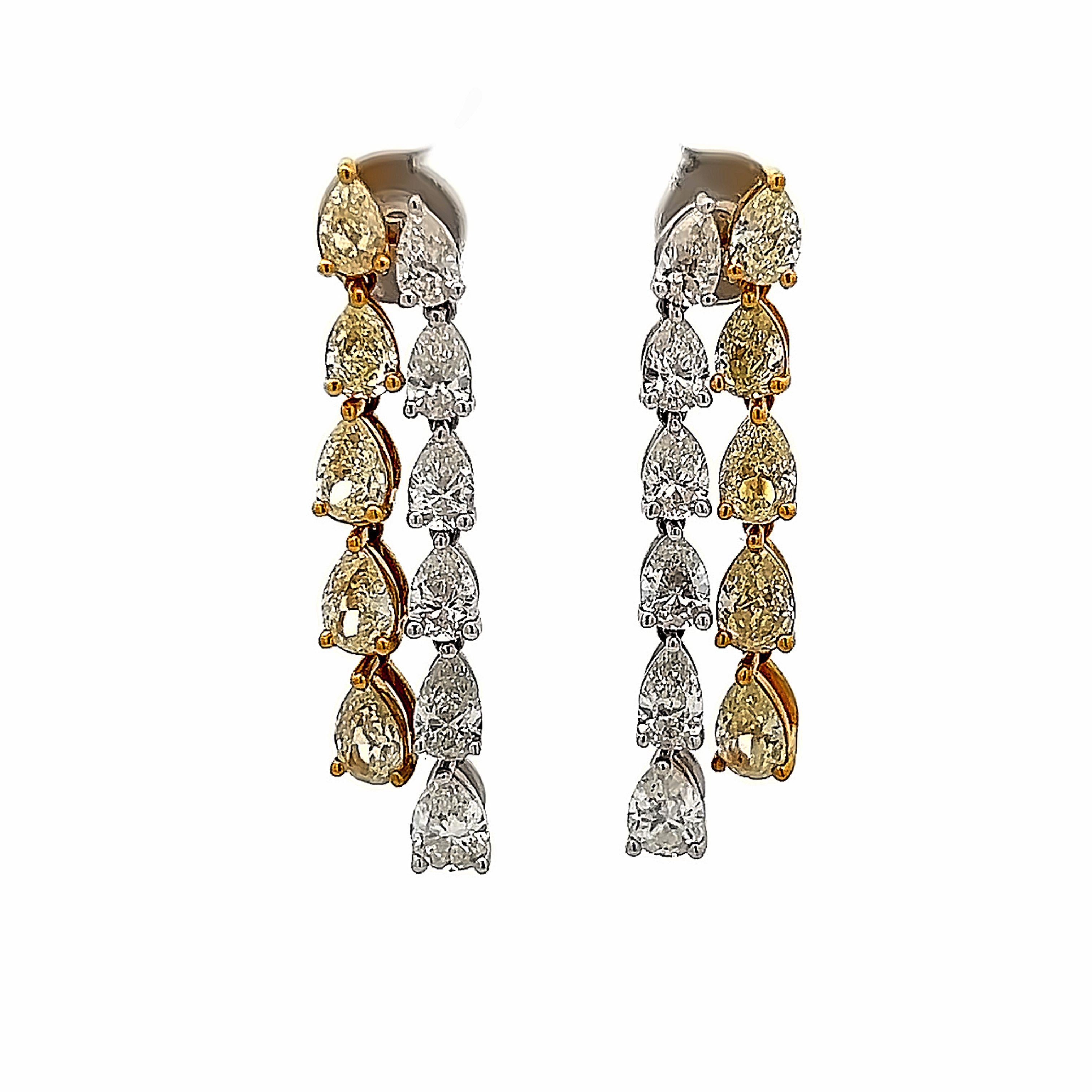Stunning pear shape fancy yellow diamond with oval diamond drop earrings. High jewelry by Alexander Beverly Hills.
7.34 carats total diamond weight.
*Fancy yellow diamonds look fancy intense in the mounting.
10 pear shape diamonds, 3.75 carats.
