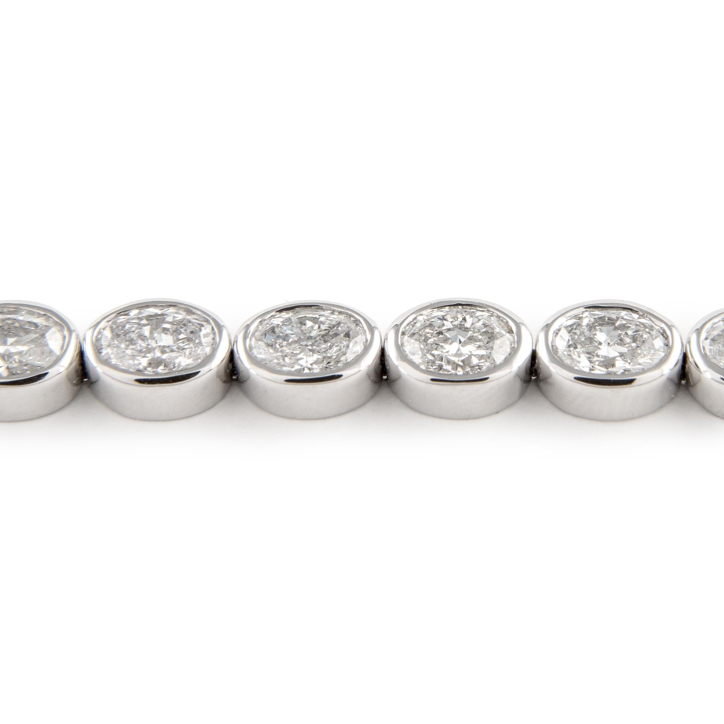 Stunning modern east-west bezel set diamond tennis bracelet. High jewelry by Alexander Beverly Hills.
27 oval cut diamonds, 8.51 carats. Approximately F/G color and SI clarity. 18k white gold, 14.93 grams, 7 inches.
Accommodated with an up-to-date