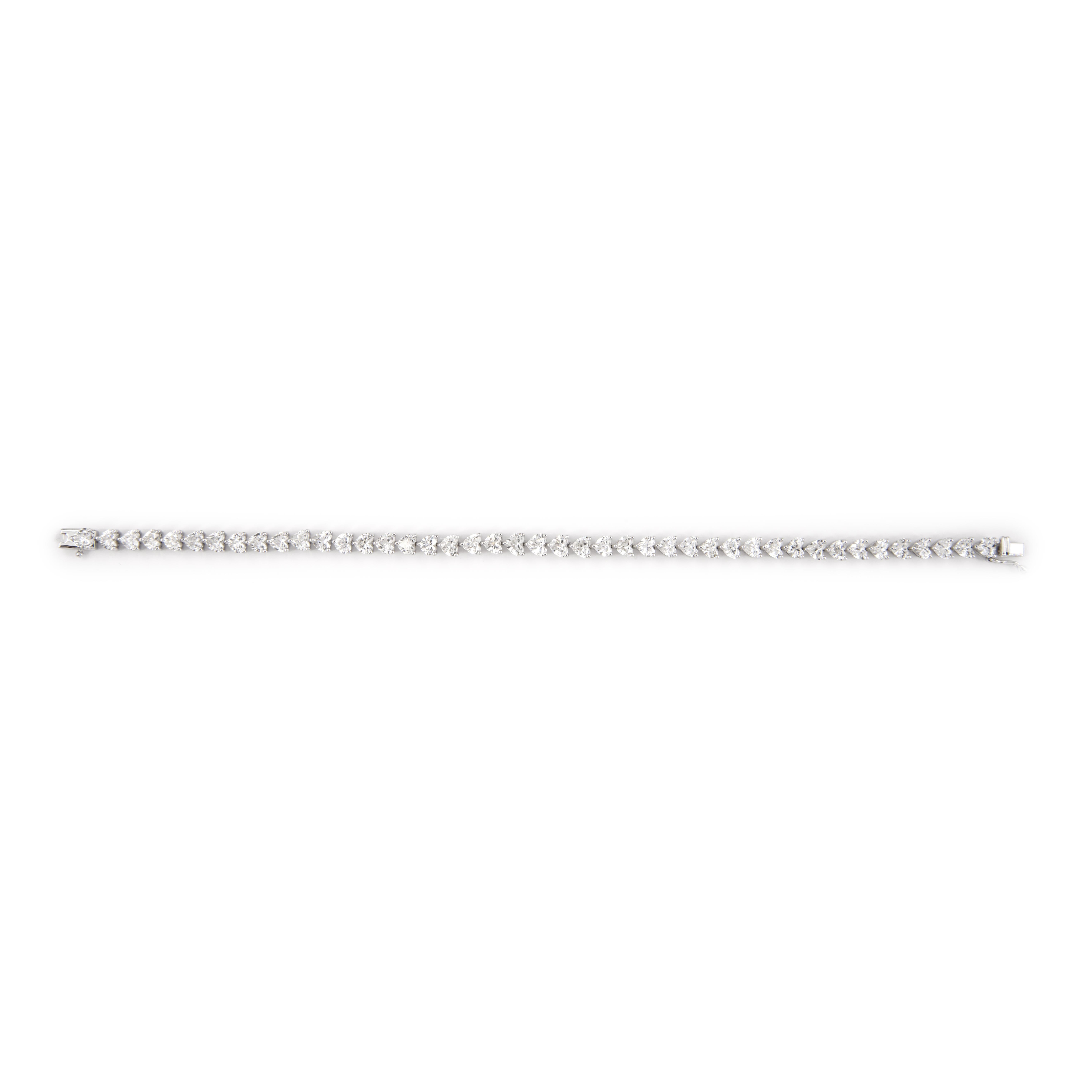 Exquisite and timeless diamond three-prong tennis bracelet, by Alexander Beverly Hills.
43 heart brilliant diamonds, 8.81 carats total. Approximately D/E color and VS1/VS2 clarity. Four prong set in 18-karat white gold, 10.47 grams, 7