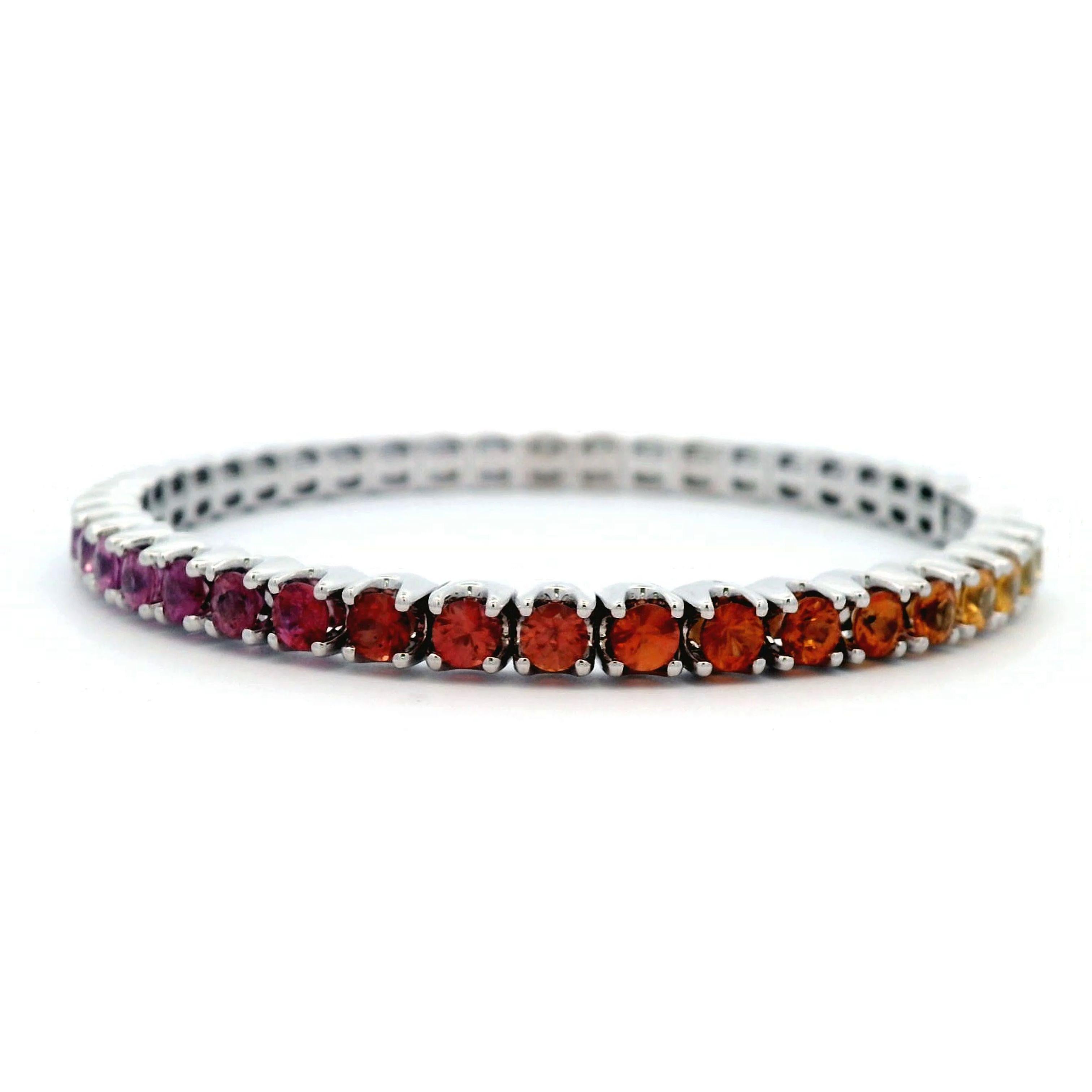 Exquisite and perfectly graduated rainbow multi color sapphire tennis flexi bracelet, by Alexander Beverly Hills.
41 round sapphires, 8.96 carats total. Four prong set in 14k white gold, 21.48 grams, 7.5 inches.
Accommodated with an up-to-date