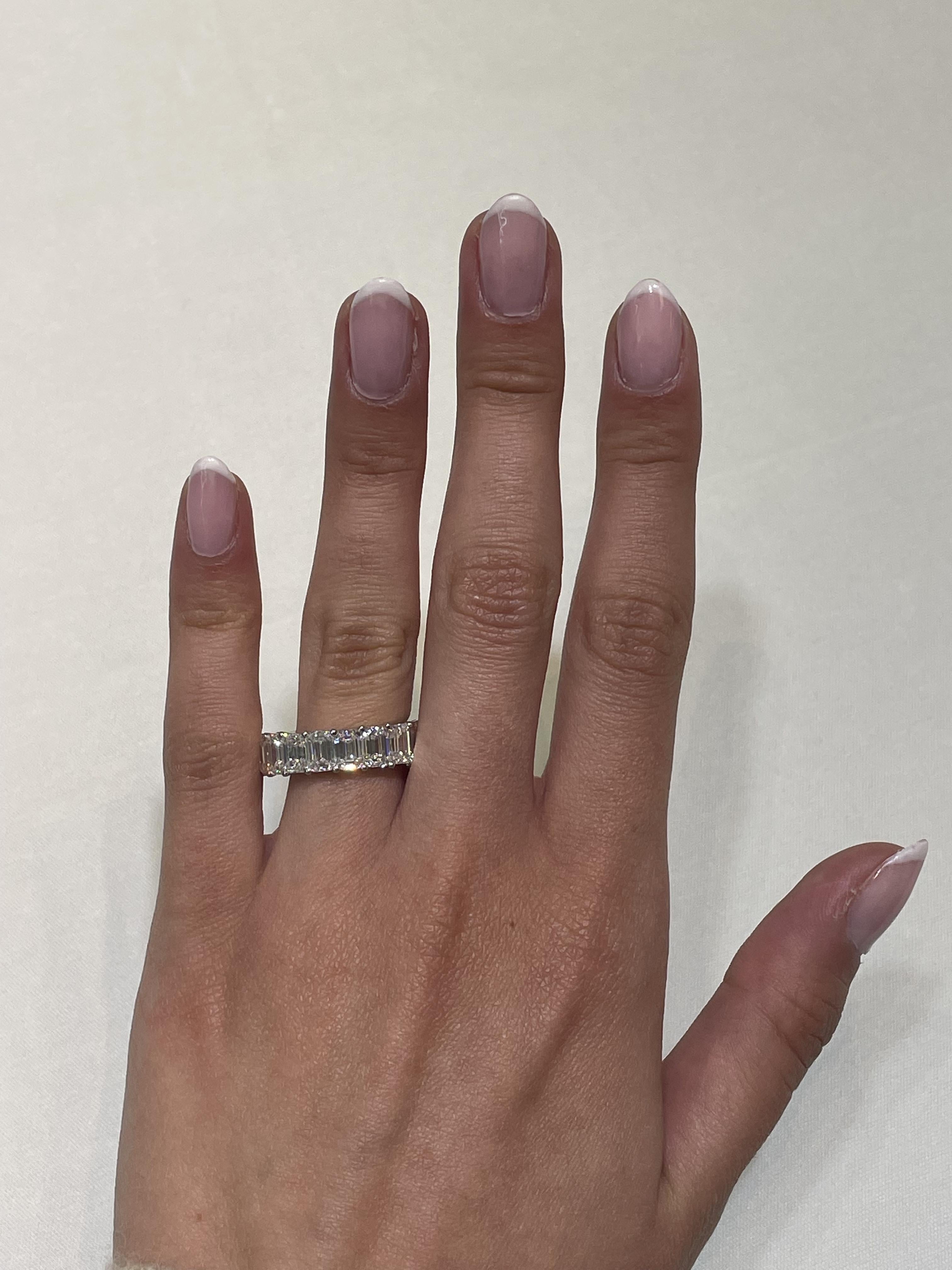 Stunning emerald cut diamond eternity band, by Alexander Beverly Hills.
18 emerald cut diamonds, 9.36 carats total. Approximately F/G color and VS1 clarity. 4 prong set in 18-karat white gold, 3.98 grams, size 5.75.
Accommodated with an up to date