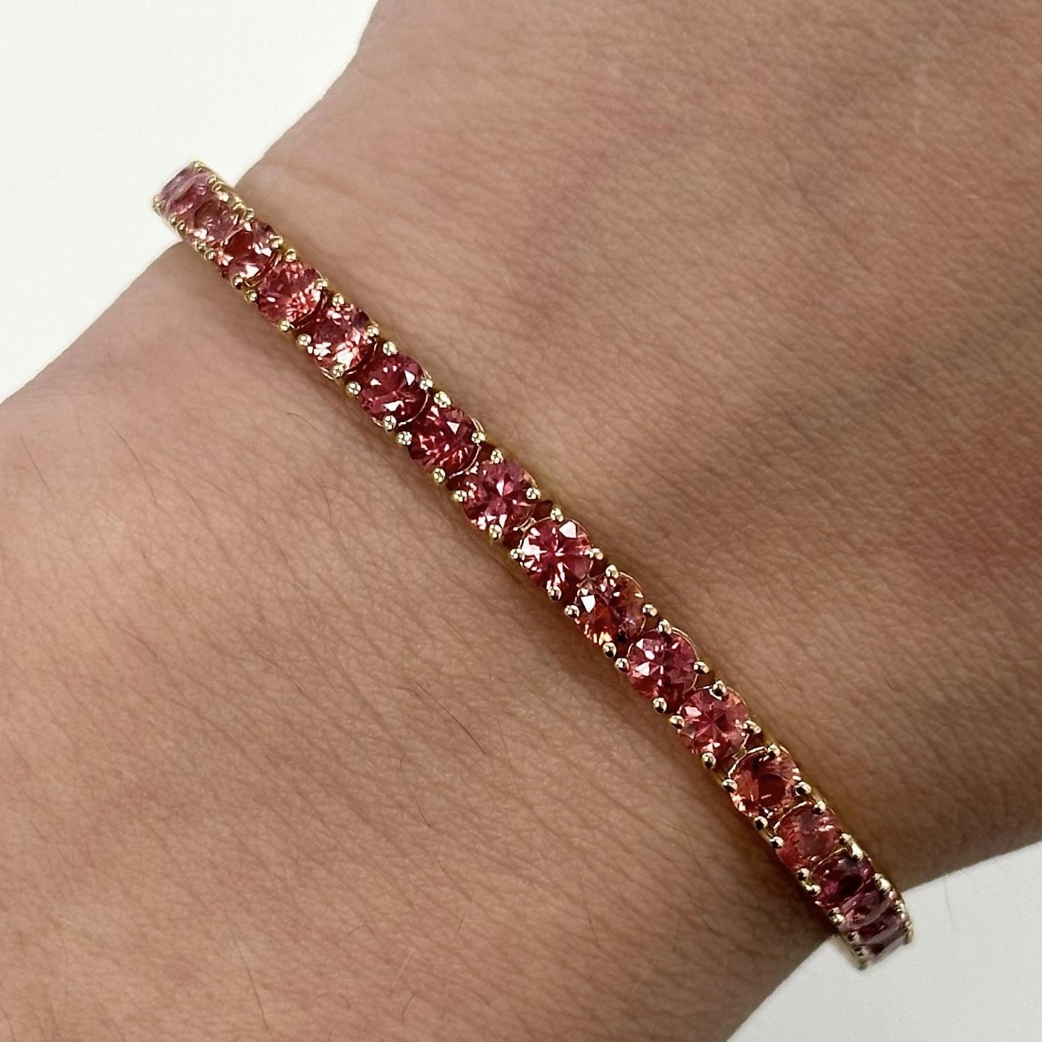 Exquisite peach / pink sapphires tennis bracelet, by Alexander Beverly Hills.
48 round pink sapphires, 9.37 carats total. Four prong set in 18-karat yellow gold, 10.34 grams, 7 inches.
Accommodated with an up-to-date digital appraisal by a GIA G.G.