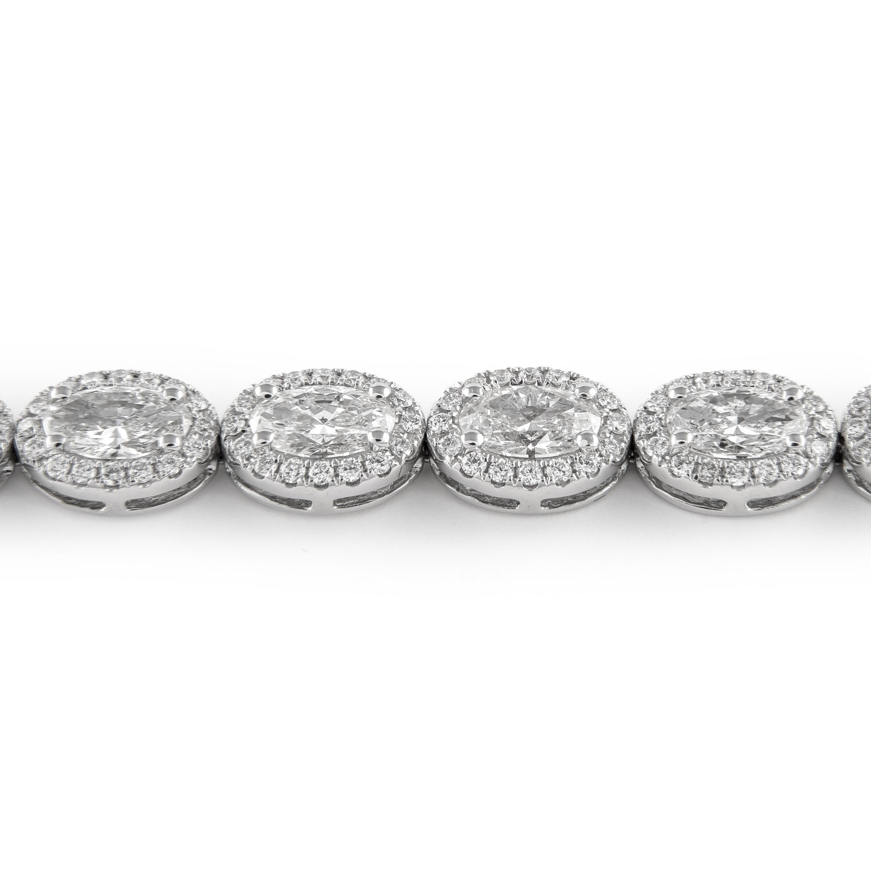 Stunning oval diamond tennis bracelet east-west. High jewelry by Alexander Beverly Hills.
8.98 carats total diamond weight.
20 oval brilliant diamonds, 8.30 carats total. Approximately F/G color and SI clarity. Complimented with 320 round diamonds,