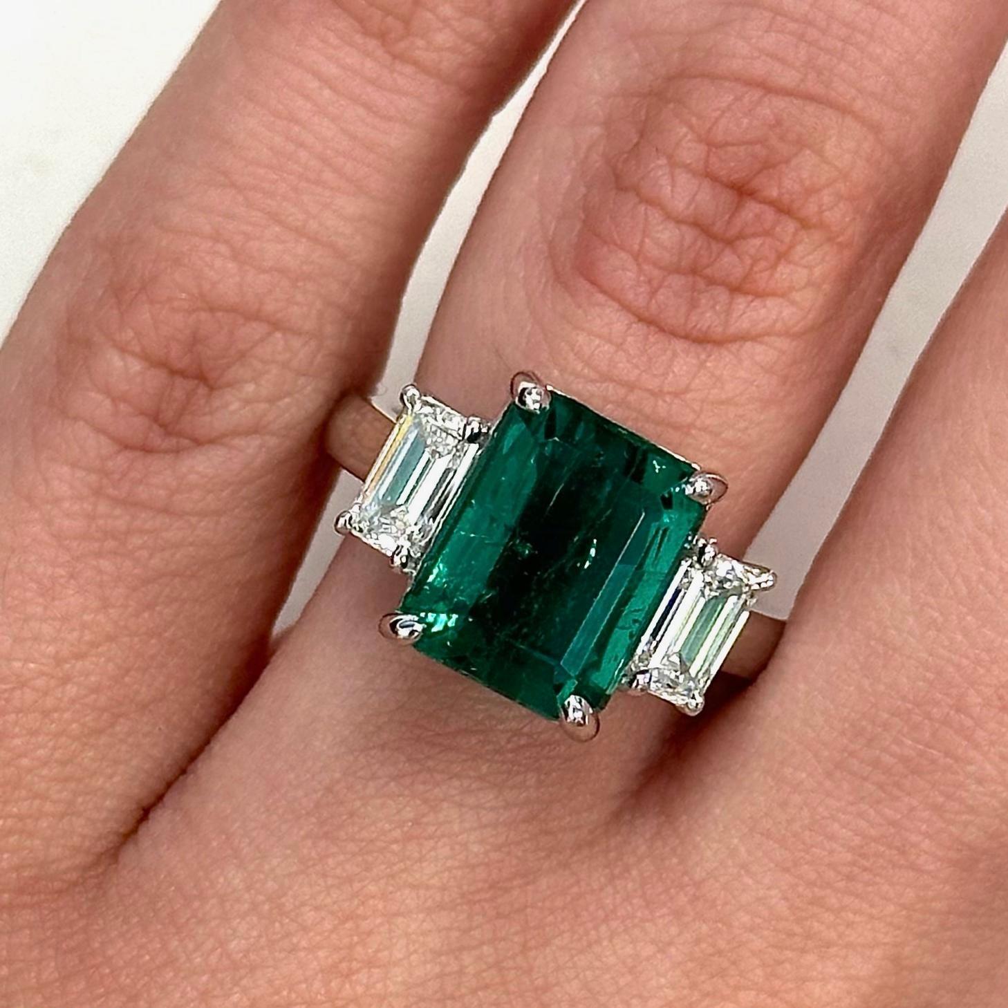 Impressive GIA certified emerald with GIA certified emerald cut diamonds three-stone ring. High jewelry by Alexander Beverly Hills.
5.74 carats total gemstone weight. 
GIA certified 4.74 carat emerald, Minor (F1). Complemented with 2 GIA certified