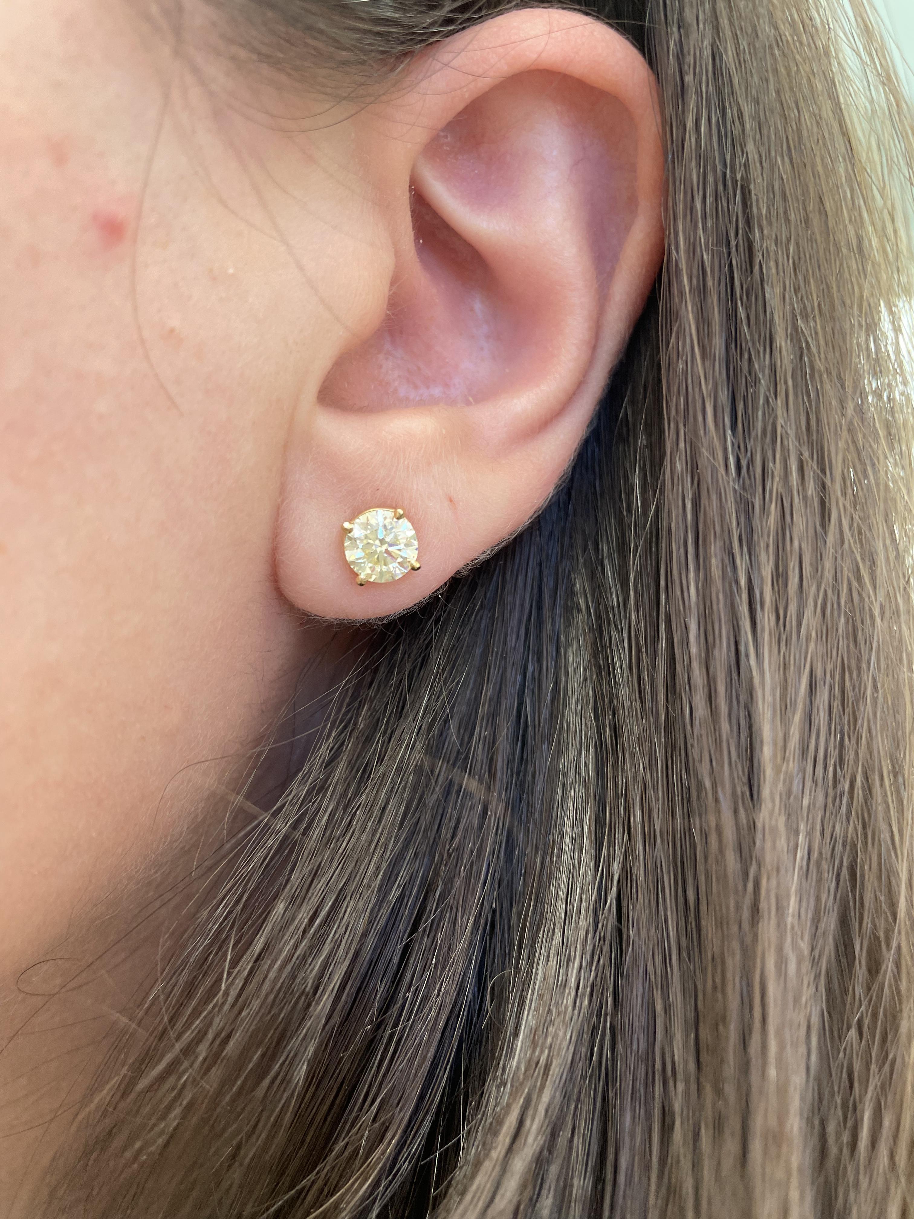 Classic diamond stud earrings.
Two matching round brilliant diamonds 1.97 carats total, EGL certified. I & J color grade, SI1 & SI2 clarity grade. Four prong set, 14k yellow gold, 1.25 grams.
Accommodated with an up-to-date appraisal by a GIA G.G.