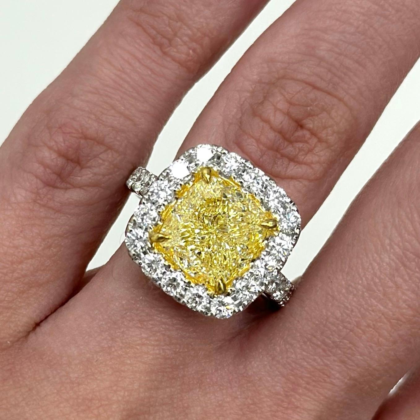 Stunning modern GIA certified fancy intense yellow diamond with diamond halo ring, two-tone 18k white and yellow gold. 
High jewelry by Alexander Beverly Hills.
6.56 carats total diamond weight.
5.03 carat cushion Fancy Intense Yellow color and SI1
