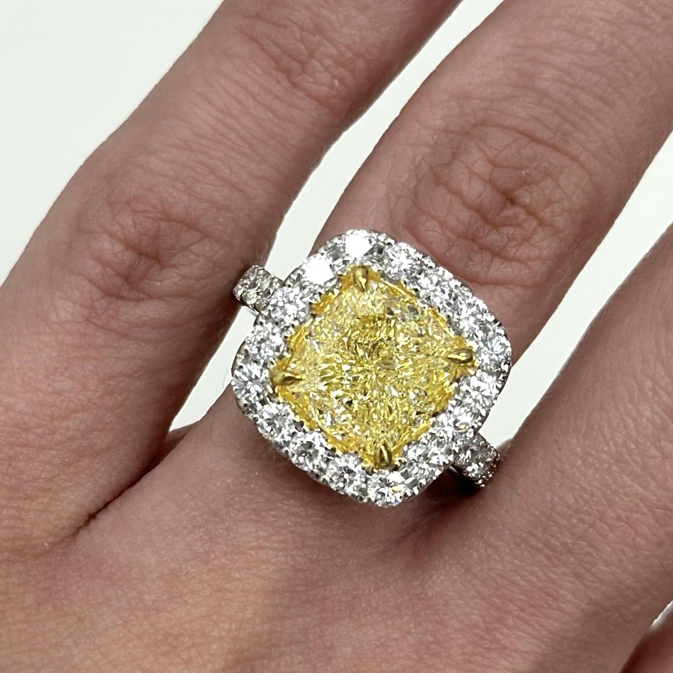 Stunning modern GIA certified fancy yellow diamond with diamond halo ring, two-tone 18k white and yellow gold.
High jewelry by Alexander Beverly Hills.
6.81 carats total diamond weight.
5.34 carat cushion Fancy Yellow color and VVS1 clarity diamond,