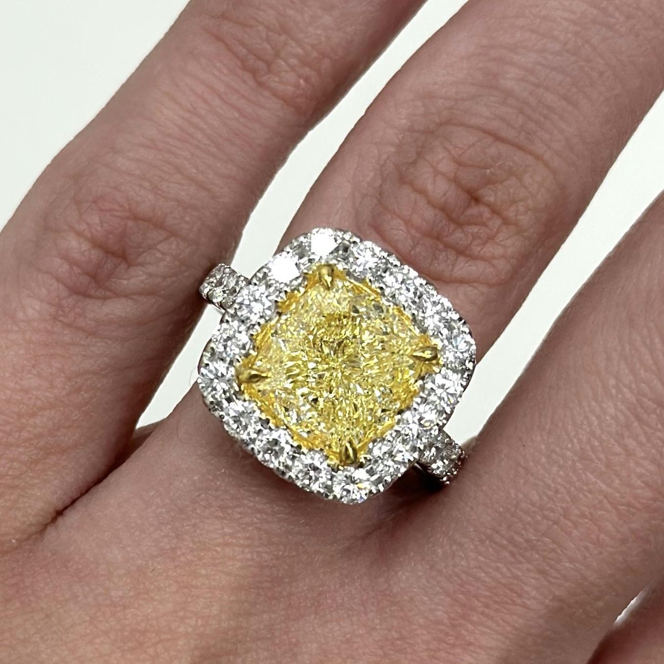 Stunning modern GIA certified fancy intense natural yellow diamond with diamond halo ring, two-tone 18k white and yellow gold.
High jewelry by Alexander Beverly Hills.
6.56 carats total diamond weight.
5.03 carat cushion Fancy Intense Yellow color
