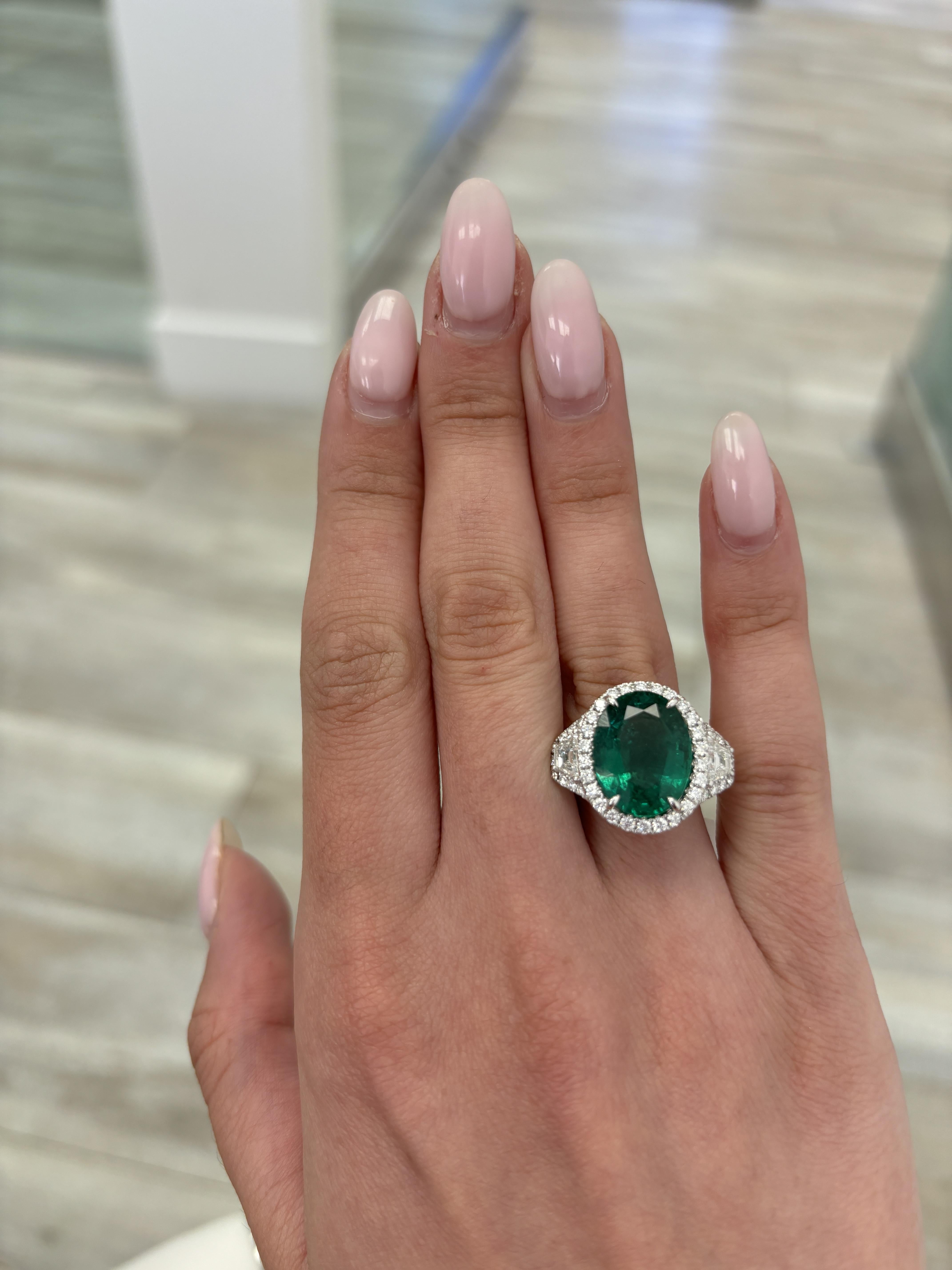 Stunning no oil vivd green natural emerald of superb color with natural diamond three stone halo ring, GIA certified. High jewelry by Alexander Beverly Hills.
8.98 carats total gemstone weight.
7.56 carat natural oval emerald, no oil, GIA certified.