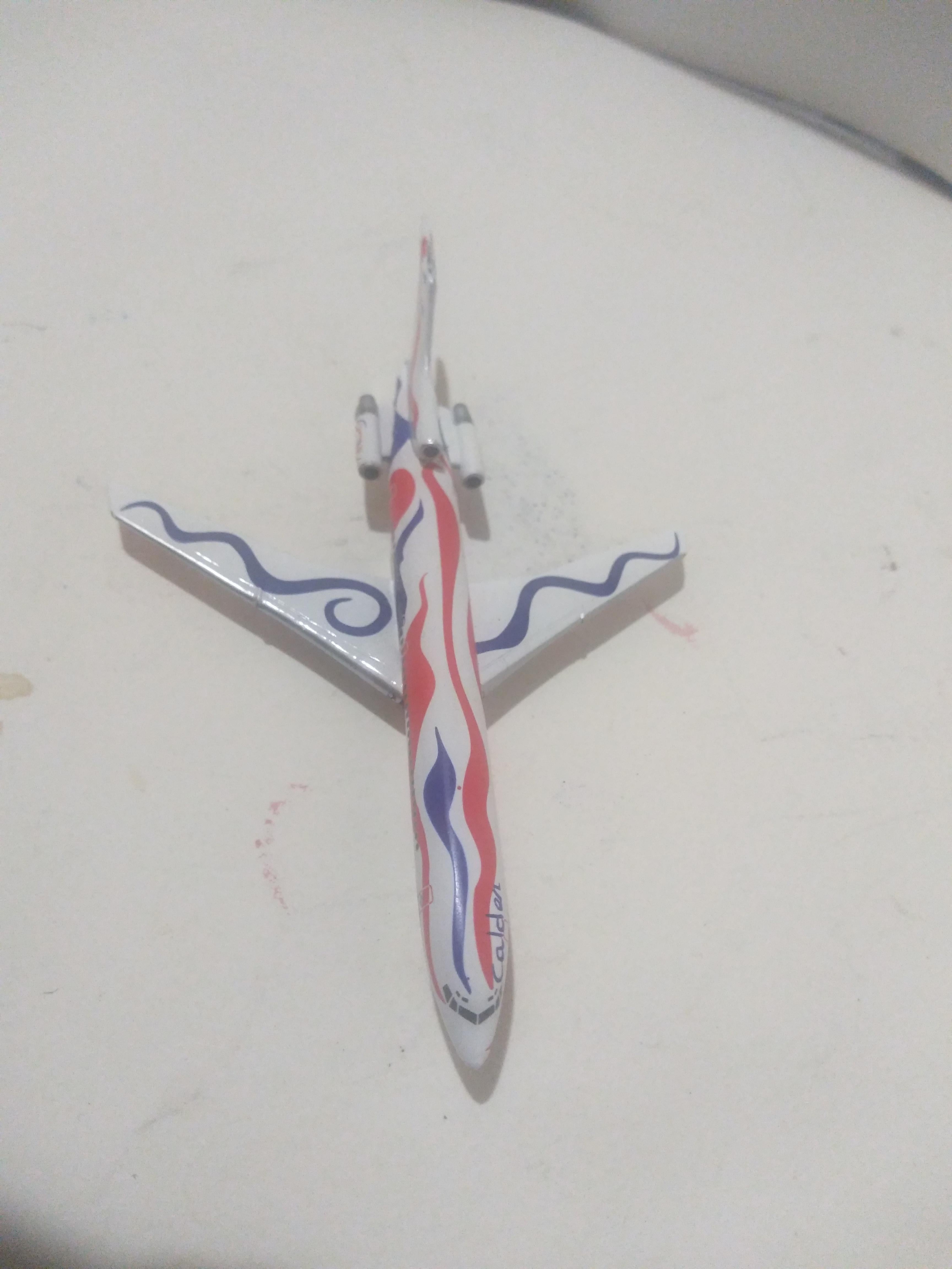 This is a miniature examples of the MacDonough-Douglass created airplane for Braniff Airlines. The airplane was painted by Alexander Calder. The plane is made of metal. It's a 1/600 scale plane and is quite collectible.

Rear rudder damage.
See pics.