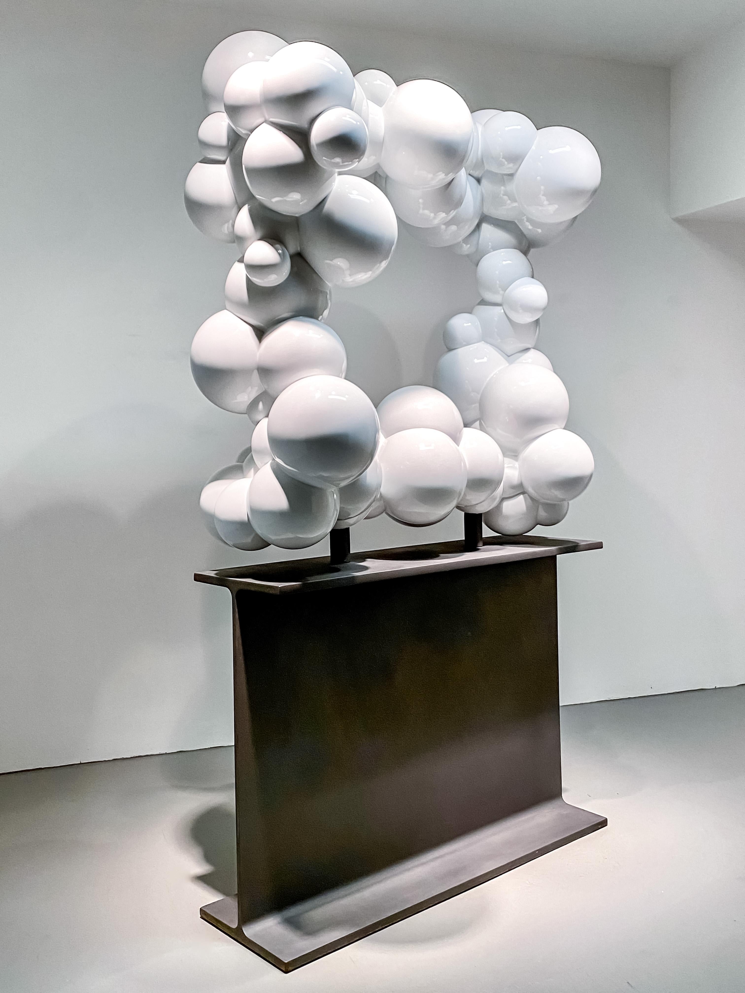This playful pop art-inspired large indoor sculpture is by Calgary’s Alexander Caldwell. Stainless steel balls in various sizes are welded to create a square frame of ‘clouds’--each ball coated in glossy bright white. Caldwell meticulously adds