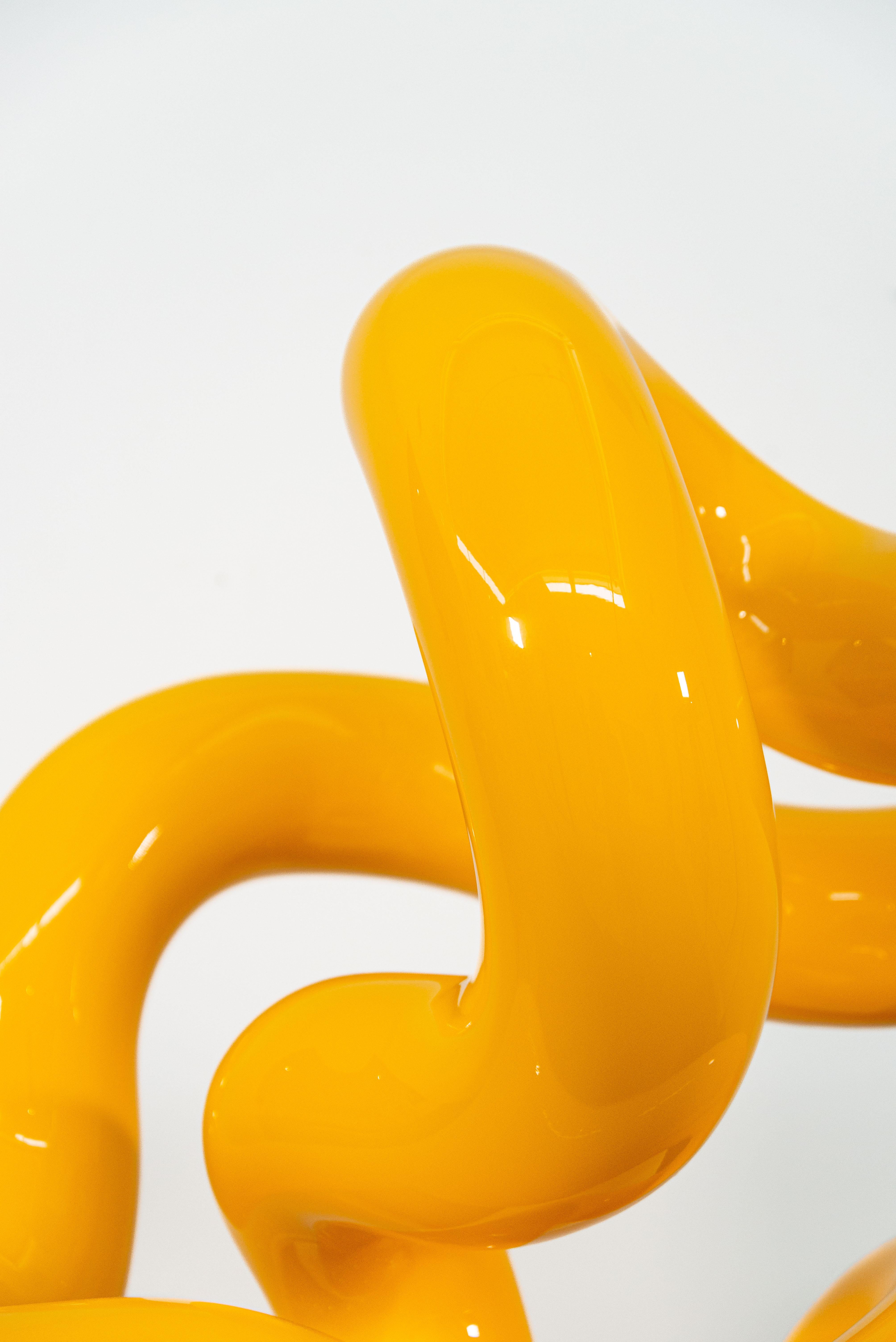 La couleur jaune vif et brillante de cette sculpture attachante accentue sa forme élégante.
Voici Alexander Caldwell. L'artiste basé à Calgary est connu pour ses pièces ludiques et minimalistes forgées à partir d'acier inoxydable et recouvertes