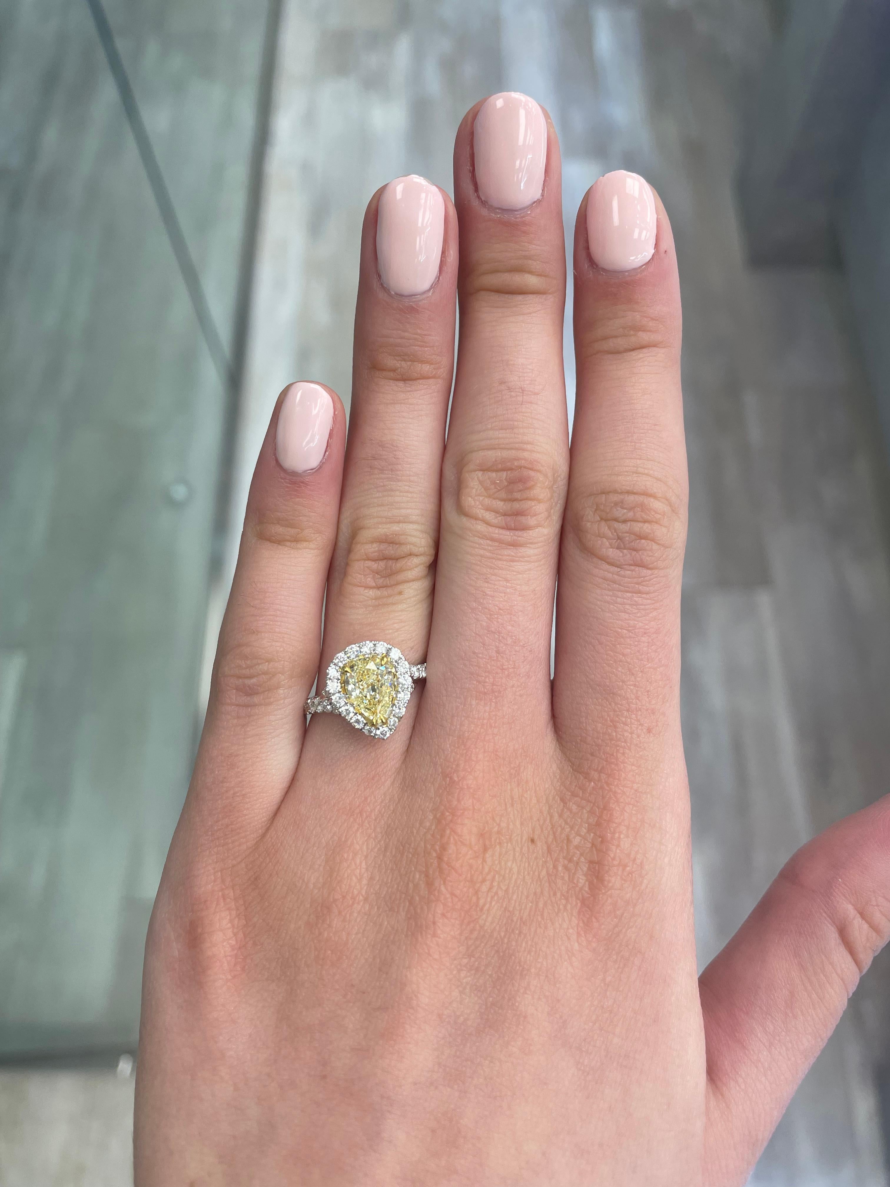 Stunning modern EGL certified yellow diamond with halo ring, two-tone 18k yellow and white gold. By Alexander Beverly Hills
1.89carats total diamond weight.
1.23 carat pear shape Fancy Yellow color and SI2 clarity diamond, EGL graded. Complimented