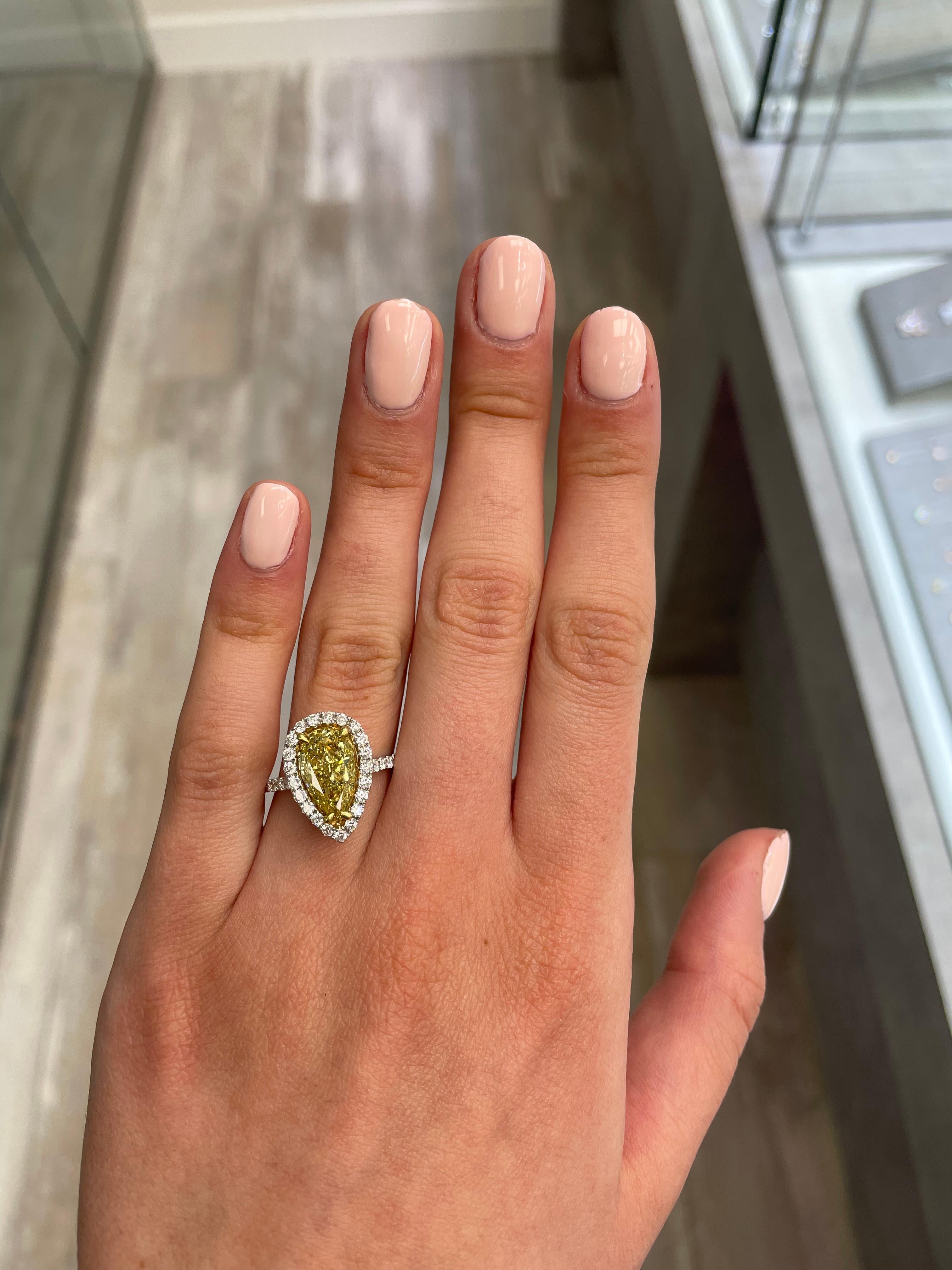 Stunning modern EGL certified yellow diamond with halo ring, two-tone 18k yellow and white gold. By Alexander Beverly Hills
2.90 carats total diamond weight.
2.25 carat pear cut Fancy Vivid Yellow color and SI3 clarity diamond, EGL graded.